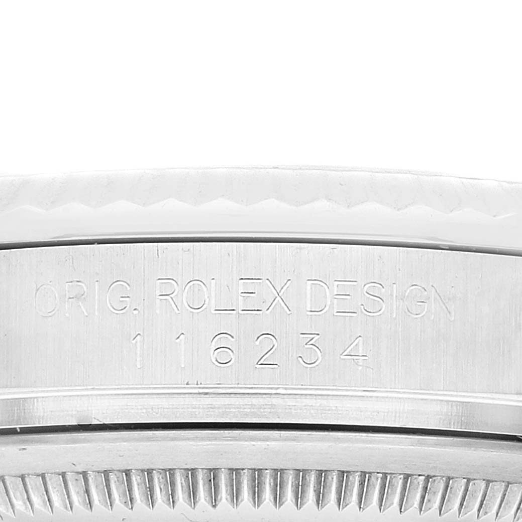 This close-up image shows the model number and part of the bezel of a Rolex Datejust 116234 Men's Stainless Steel Silver Dial 116234 Men's Stainless Steel Silver Dial watch.