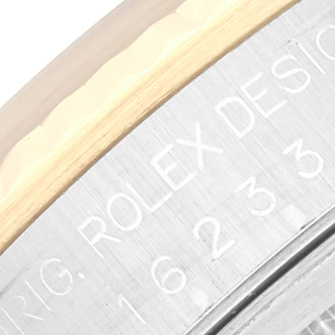 This close-up image shows the engraved side of the bezel on the Rolex Datejust 16233 Men's Steel and Gold (two tone) Black Dial 16233 Men's Steel and Gold (two tone) Black Dial watch.
