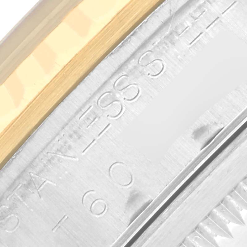 This close-up of the Rolex Datejust 16233 Men's Steel and Gold (two tone) Black Dial 16233 Men's Steel and Gold (two tone) Black Dial watch shows the engraved side of the case and part of the bezel.