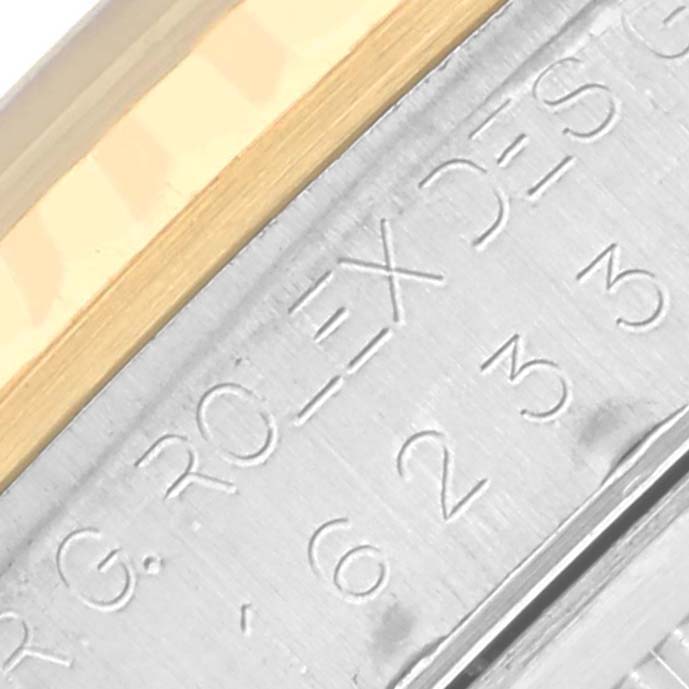 The image shows a close-up of the engraving on the side of a Rolex Datejust 16233 Men's Steel and Gold (two tone) Black Dial 16233 Men's Steel and Gold (two tone) Black Dial watch’s case.