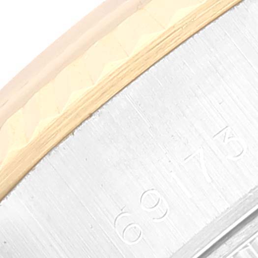 The image shows a close-up of the edge of the bezel and case of a Rolex Datejust 69173 Women's Steel and Gold (two tone) Black Dial 69173 Women's Steel and Gold (two tone) Black Dial watch.