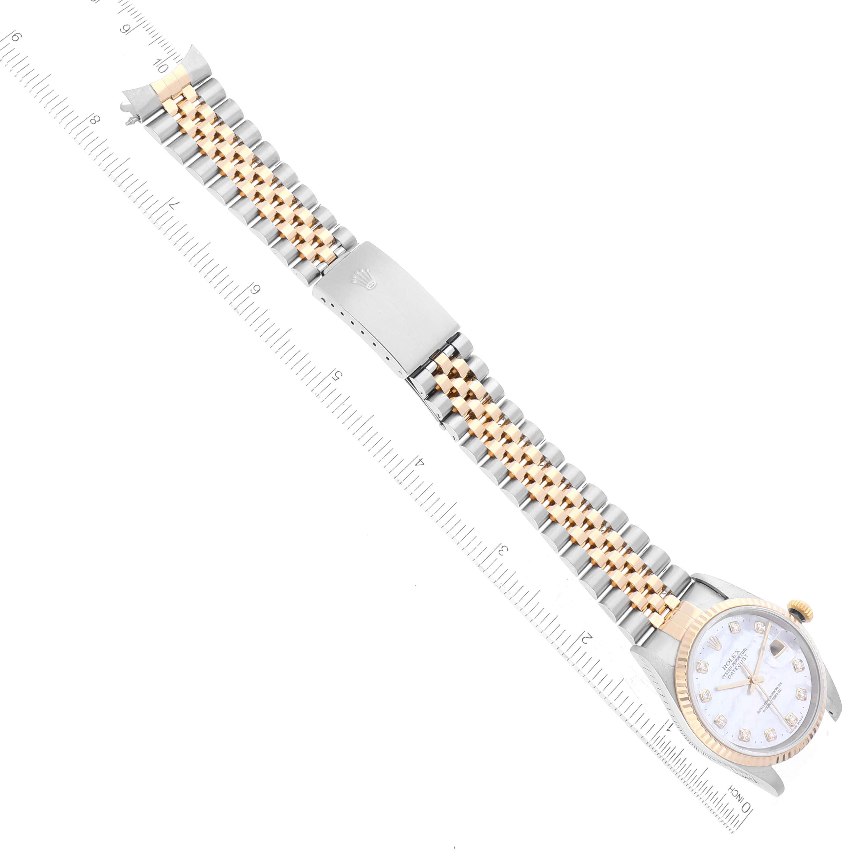 The image shows a Rolex Datejust 16233 Men's Steel and Gold (two tone) Mother of Pearl Dial 16233 Men's Steel and Gold (two tone) Mother of Pearl Dial watch laid flat, displaying the dial, bracelet, and clasp with a ruler for measurement.