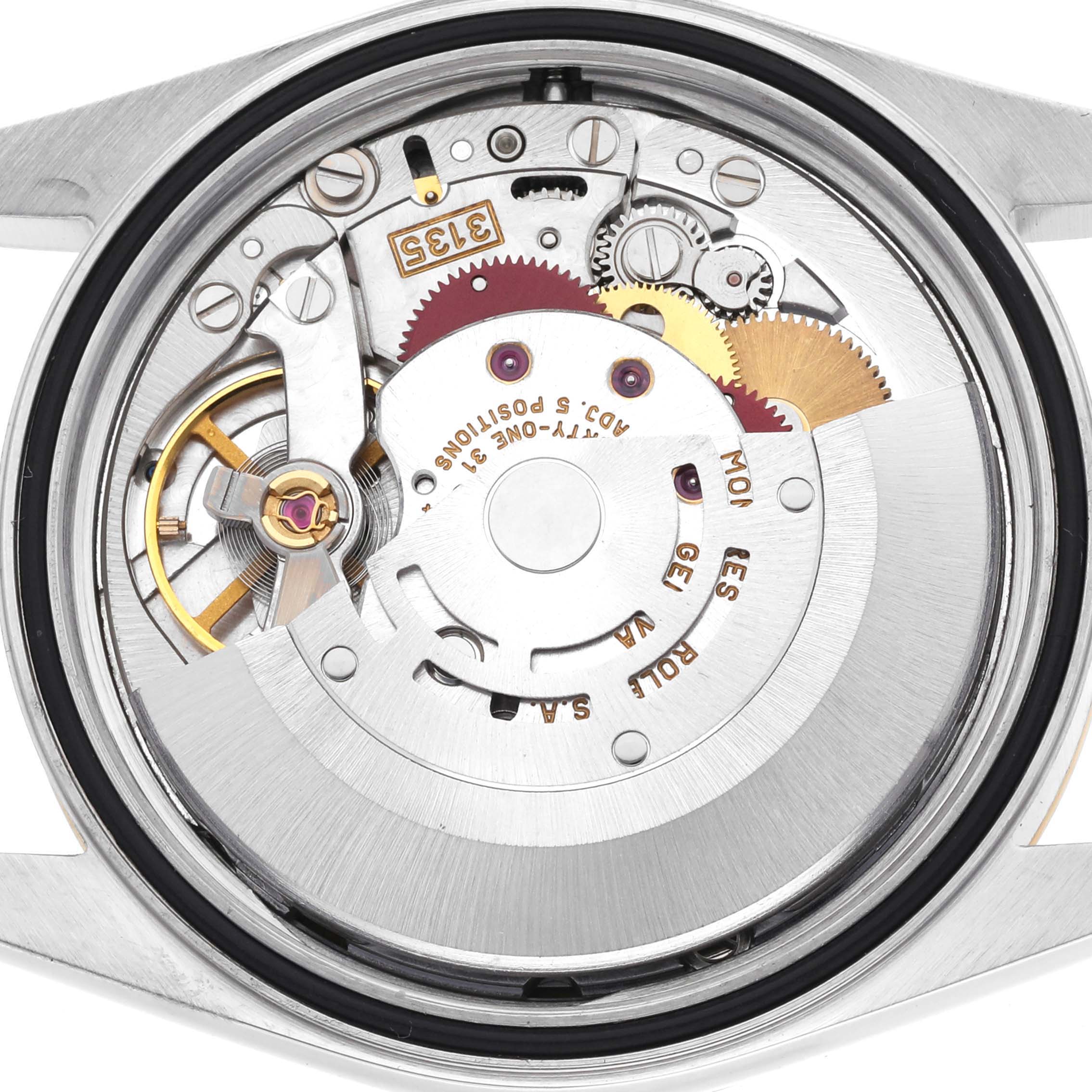 The image shows the movement of a Rolex Datejust 16203 Men's Steel and Gold (two tone) Grey Dial 16203 Men's Steel and Gold (two tone) Grey Dial watch from the back, displaying gears and mechanical parts.