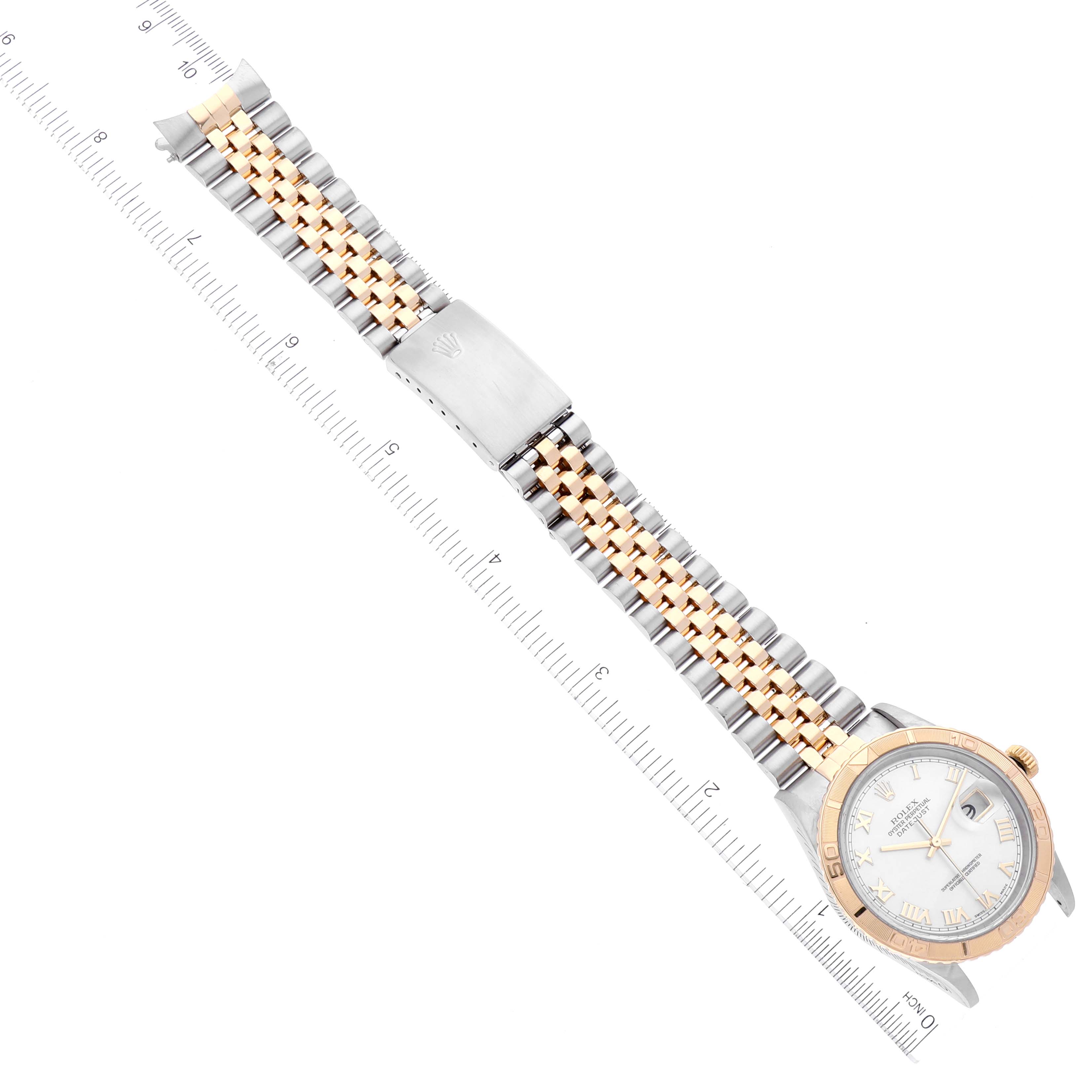 The image shows a full view of a Rolex Turn-o-Graph 16263 Men's Steel and Gold (two tone) Mother of Pearl Dial 16263 Men's Steel and Gold (two tone) Mother of Pearl Dial watch, detailing its face, bezel, and two-tone bracelet, positioned alongside a ruler.