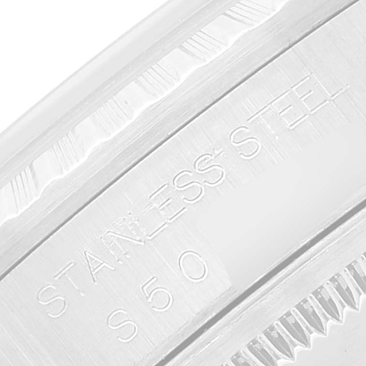 This close-up image shows the engraving on the stainless steel bezel of a Rolex Datejust 16220 Men's Stainless Steel White Dial 16220 Men's Stainless Steel White Dial watch.