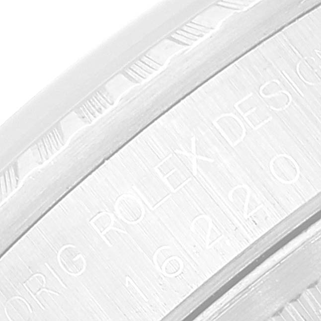 This image shows an extreme close-up of the engravings on the inner bezel of a Rolex Datejust 16220 Men's Stainless Steel White Dial 16220 Men's Stainless Steel White Dial watch.