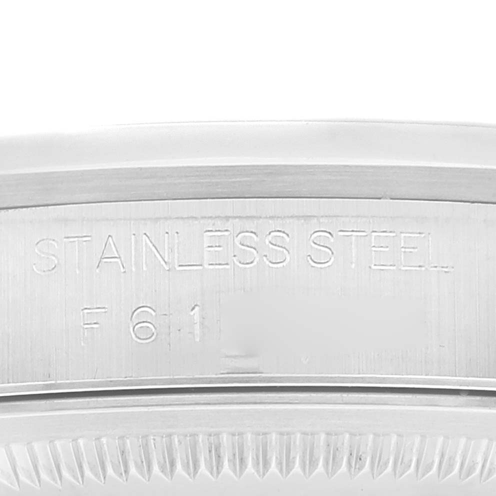 The image shows a close-up of the serial number and "Stainless Steel" engraving on the case of a Rolex Datejust 16200 Men's Stainless Steel White Dial 16200 Men's Stainless Steel White Dial watch.