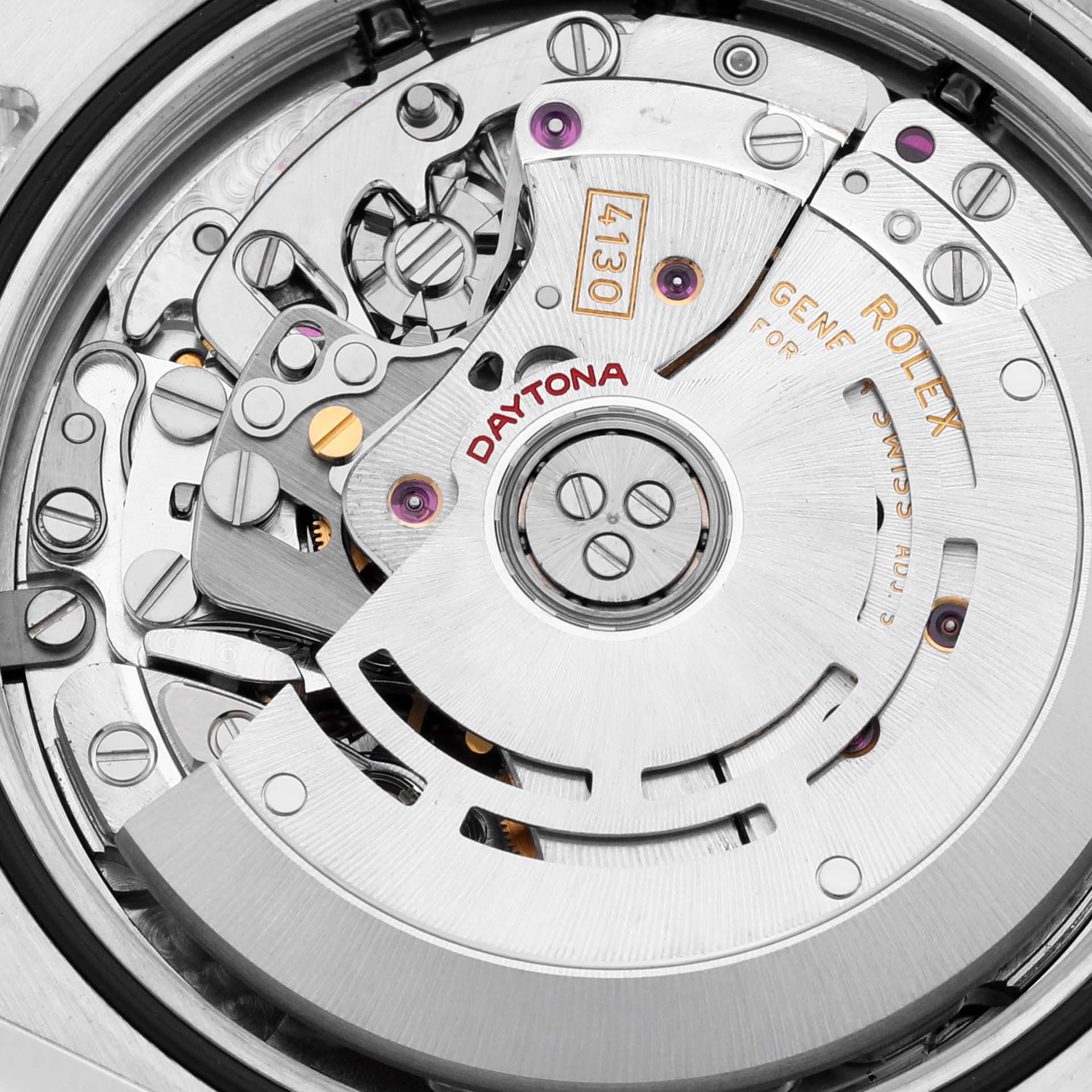 The image shows a close-up of the Rolex Daytona 116520 Men's Stainless Steel Black Dial 116520 Men's Stainless Steel Black Dial's movement, highlighting gears and engravings.