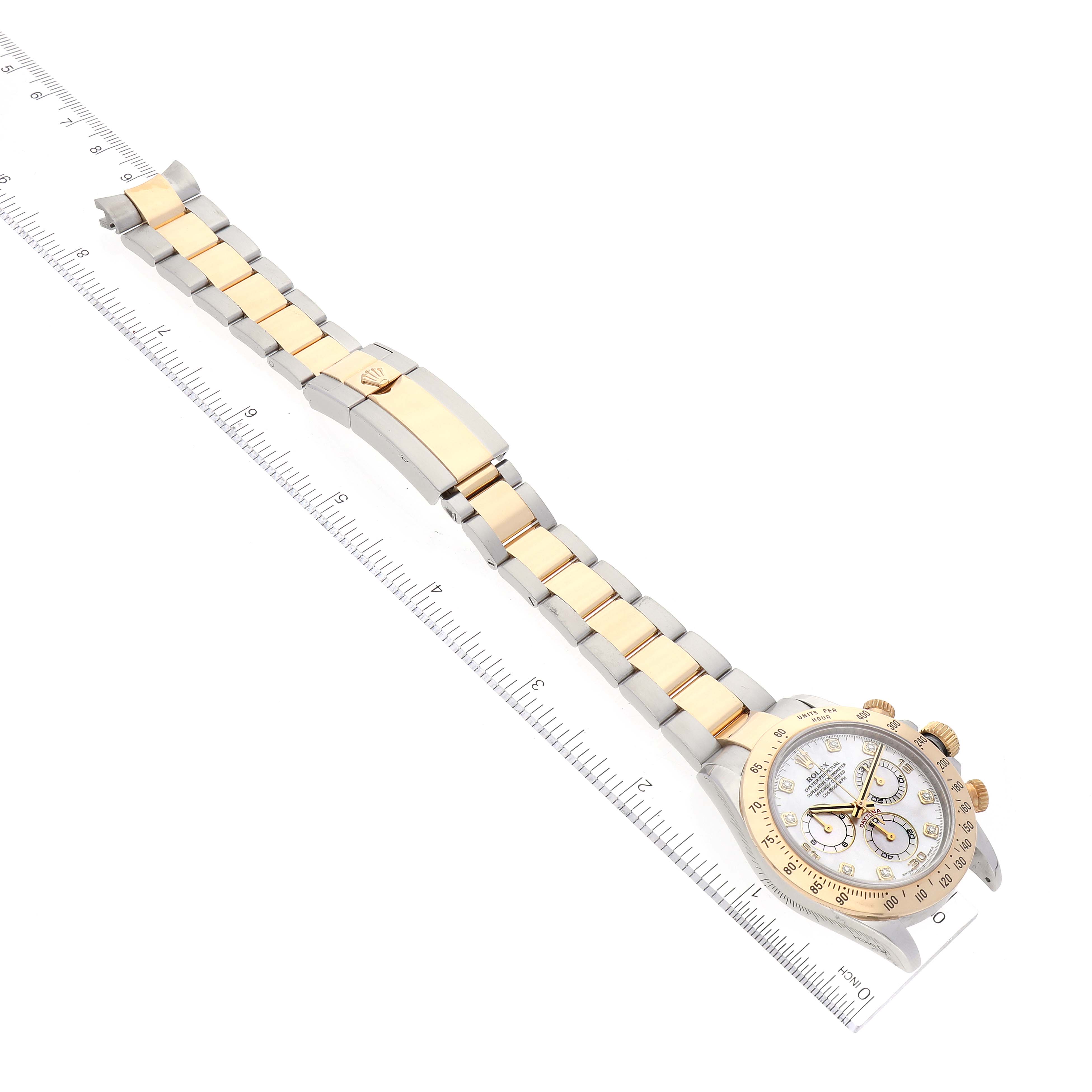 The image shows a Rolex Daytona 116523 Men's Steel and Gold (two tone) Mother of Pearl Dial 116523 Men's Steel and Gold (two tone) Mother of Pearl Dial watch laid flat, with the clasp, bracelet, and dial all visible beside a ruler.