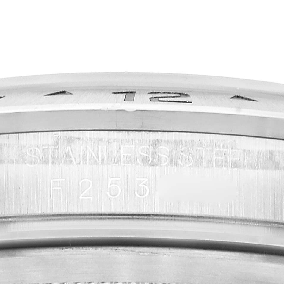 This image shows a close-up of the bezel and part of the case back from the Rolex Explorer 16570 Men's Stainless Steel White Dial 16570 Men's Stainless Steel White Dial watch, highlighting "STAINLESS STEEL" and a reference number.
