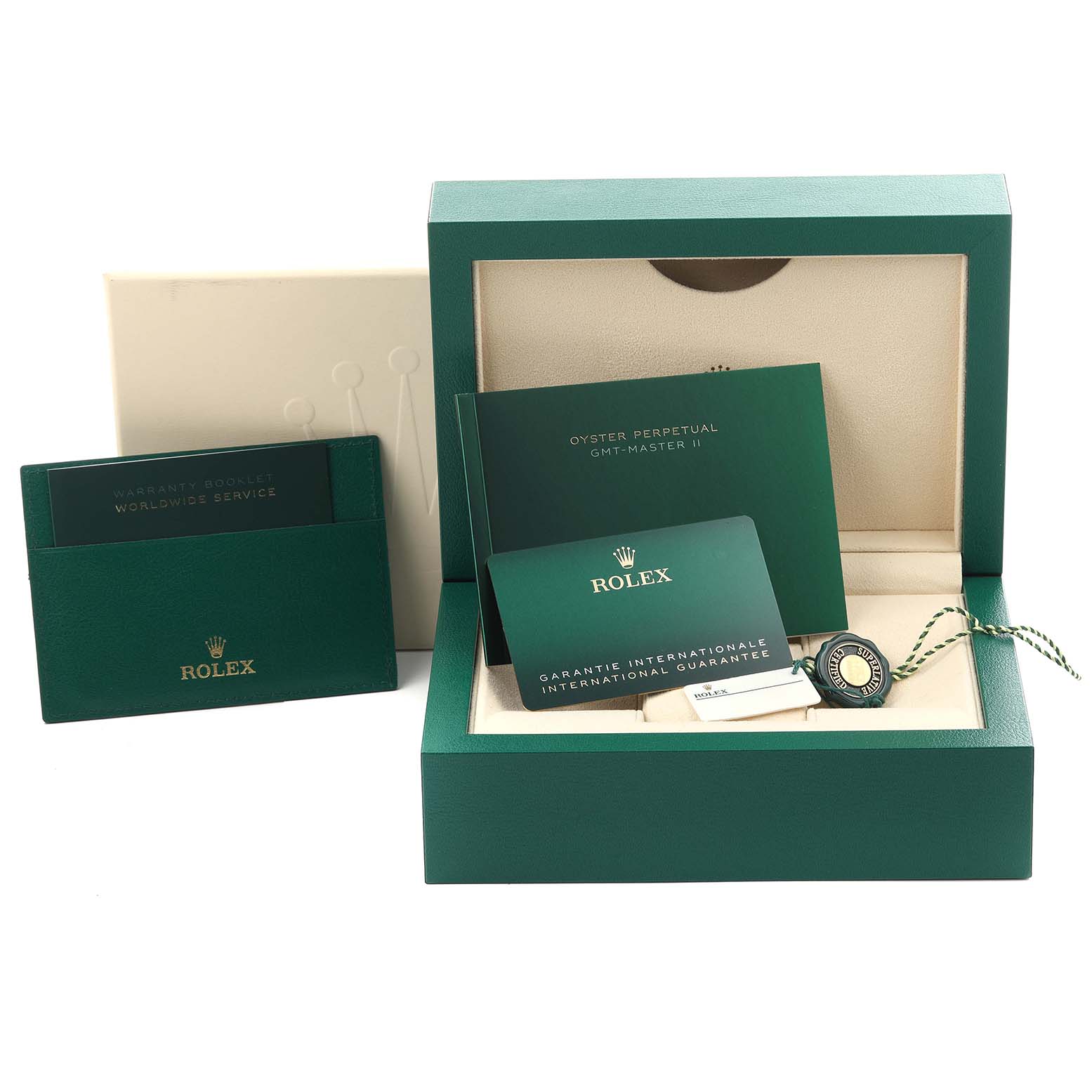 The image shows a green Rolex GMT-Master 126710 Men
s Stainless Steel Black Dial 126710 Men
s Stainless Steel Black Dial box with manuals, a guarantee card, and a tag.