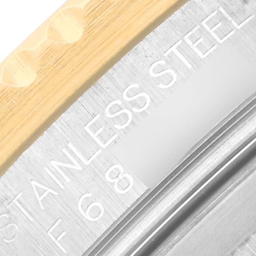 The image shows a close-up of the side and bezel of a Rolex GMT-Master 16713 Men's Steel and Gold (two tone) Brown Dial 16713 Men's Steel and Gold (two tone) Brown Dial watch, highlighting the metal texture and text.