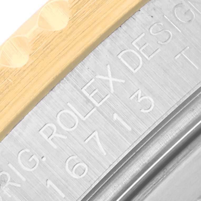 The image shows a close-up of the Rolex GMT-Master 16713 Men's Steel and Gold (two tone) Brown Dial 16713 Men's Steel and Gold (two tone) Brown Dial model's side, focusing on the engraved case and gold bezel edge.