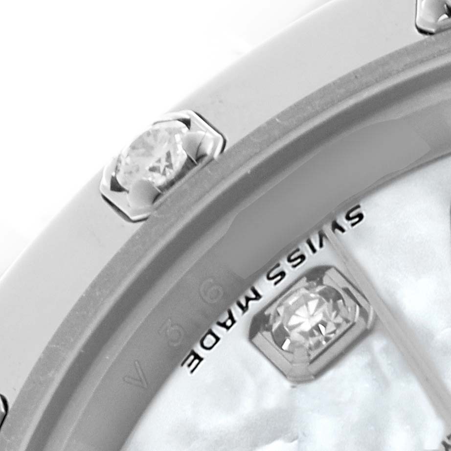 The image shows a close-up of a Rolex Pearlmaster 80319 Women
s White Gold Mother of Pearl Dial 80319 Women
s White Gold Mother of Pearl Dial watch bezel with diamonds and part of the dial.