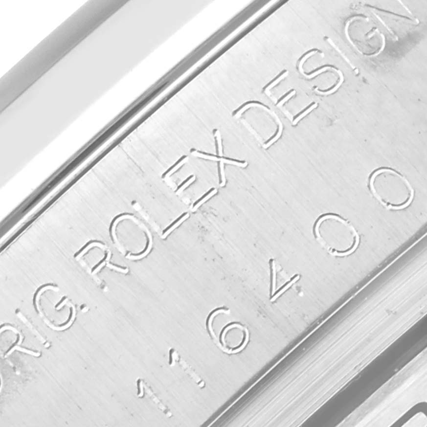 The image shows the side engraving of a Rolex Milgauss 116400 Men's Stainless Steel Black Dial 116400 Men's Stainless Steel Black Dial model, displaying "ORIG ROLEX DESIGN" and model number.