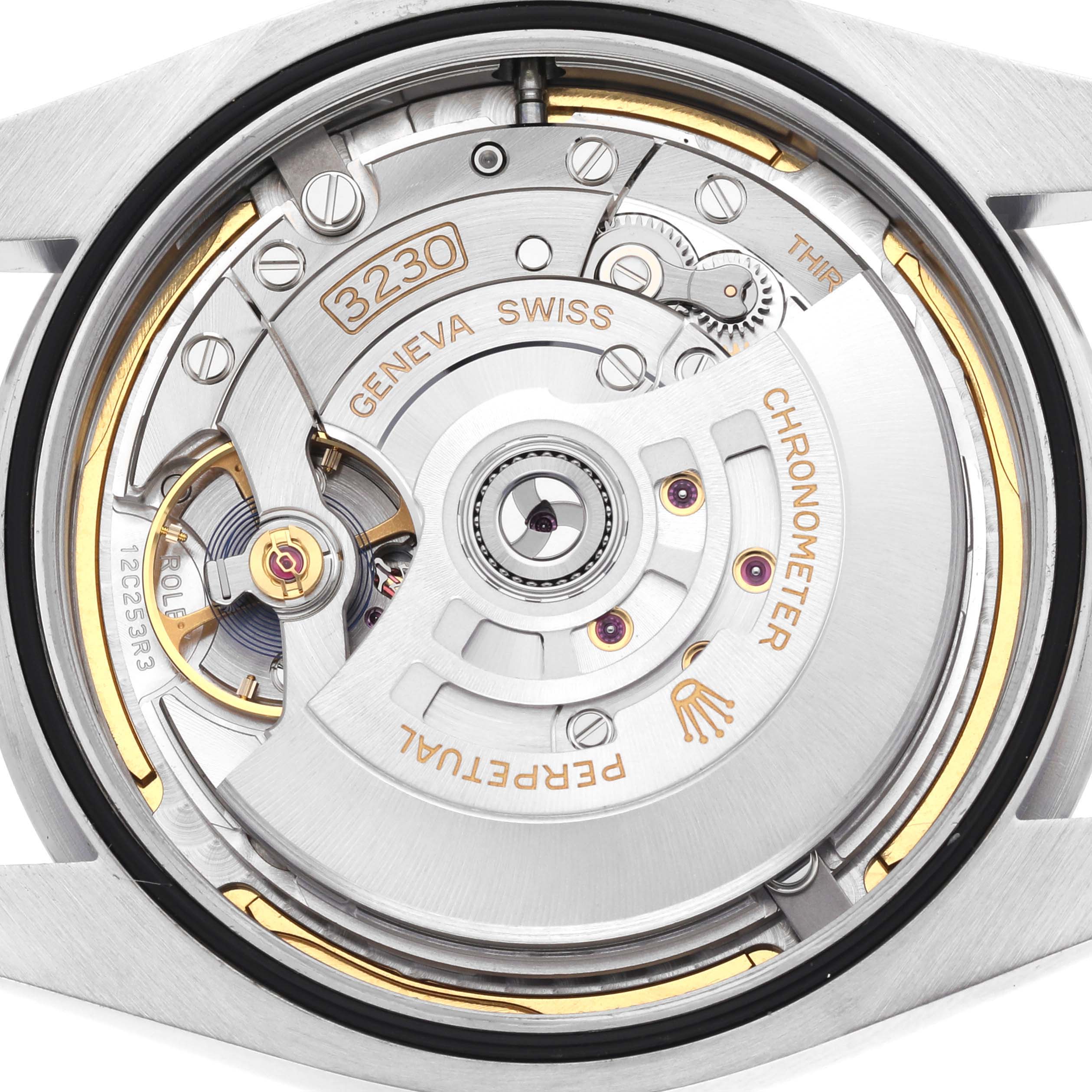 The image shows a close-up of the movement inside a Rolex Oyster Perpetual 124300 Men's Stainless Steel Blue Dial 124300 Men's Stainless Steel Blue Dial, highlighting the rotor and internal components.