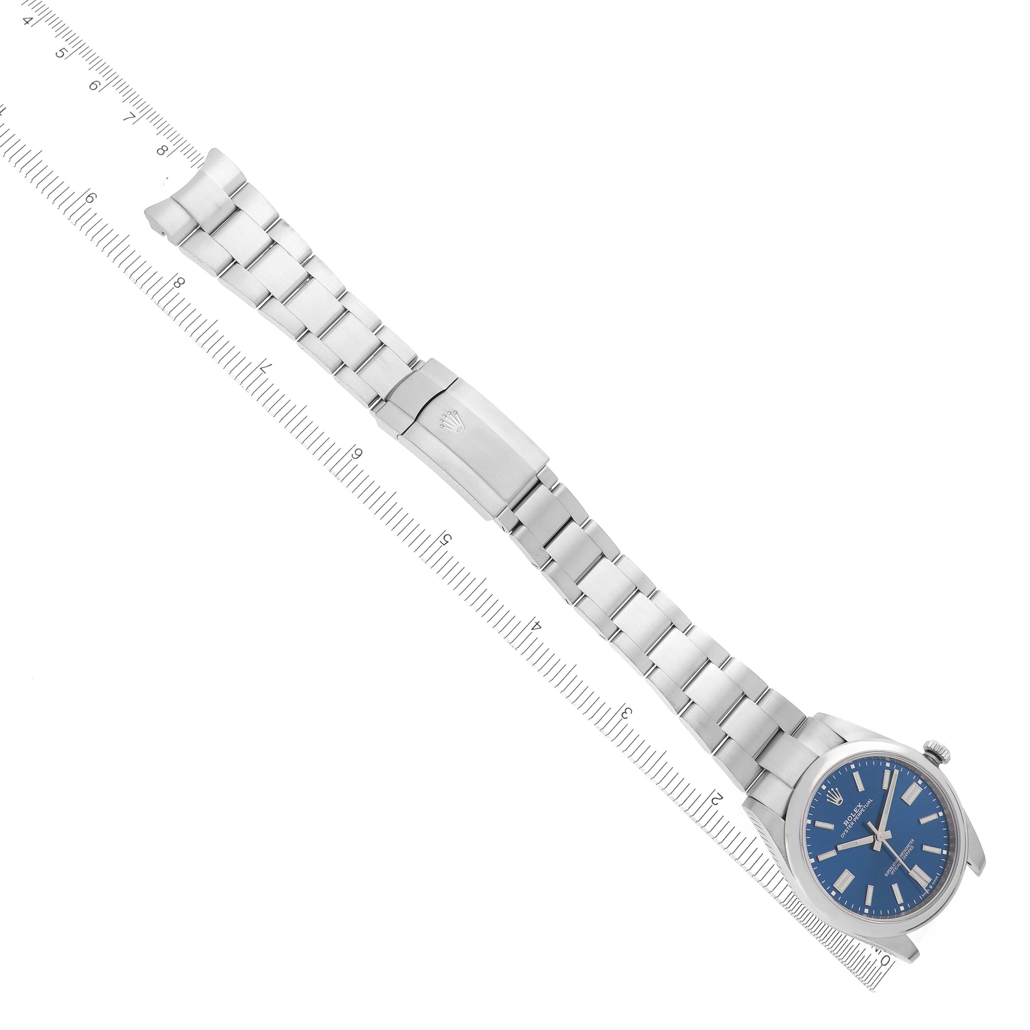 The Rolex Oyster Perpetual 124300 Men's Stainless Steel Blue Dial 124300 Men's Stainless Steel Blue Dial watch is shown from a top-down angle displaying the face, full bracelet, and clasp.
