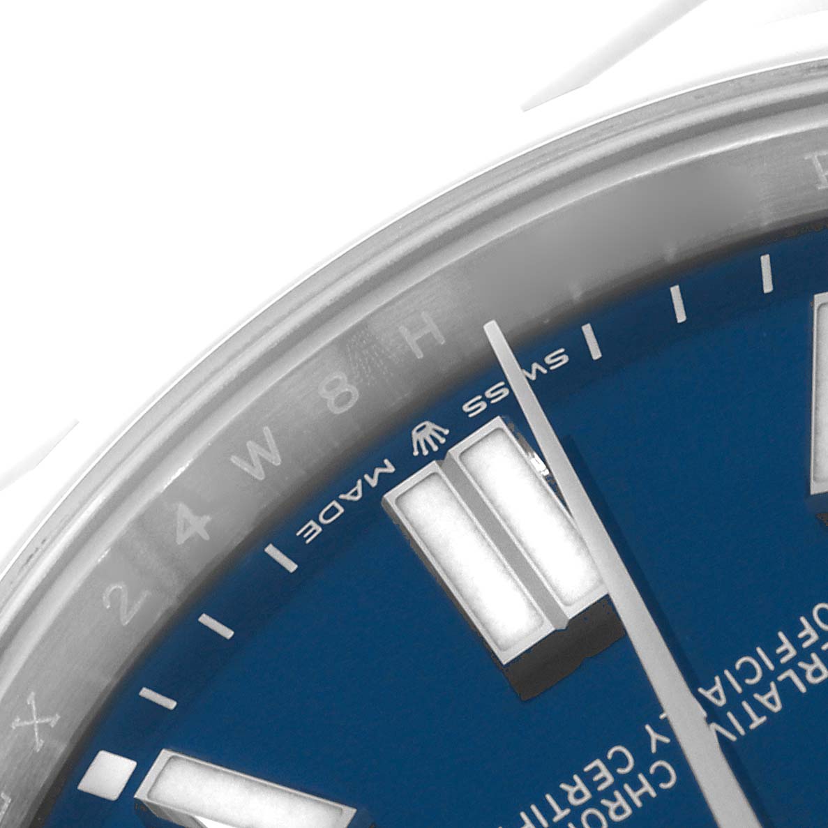 The image shows a close-up of the dial and part of the bezel of a Rolex Oyster Perpetual 124300 Men's Stainless Steel Blue Dial 124300 Men's Stainless Steel Blue Dial, highlighting the markers and hands.