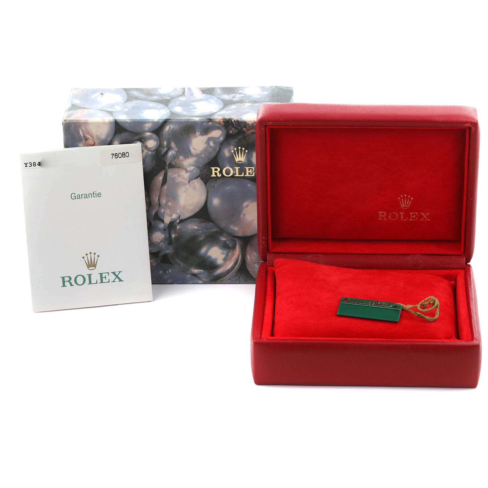 The image shows the packaging and accessories for a Rolex Oyster Perpetual 76080 Women's Stainless Steel Pink Dial 76080 Women's Stainless Steel Pink Dial, including the box, tag, and guarantee card.