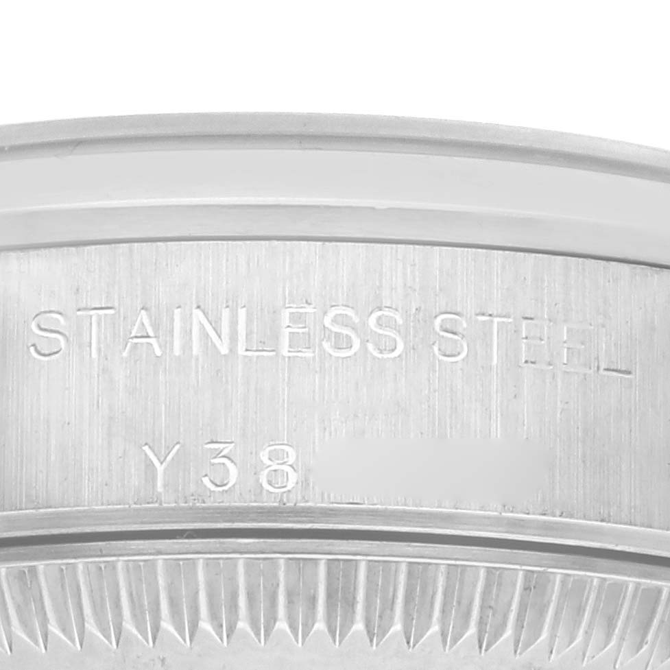 The image shows the inner bezel of a Rolex Oyster Perpetual 76080 Women's Stainless Steel Pink Dial 76080 Women's Stainless Steel Pink Dial watch with engravings indicating stainless steel material.