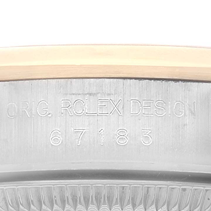 This image shows a close-up of the model number and design engravings on the side of a Rolex Oyster Perpetual 67183 Women's Steel and Gold (two tone) Grey Dial 67183 Women's Steel and Gold (two tone) Grey Dial case.