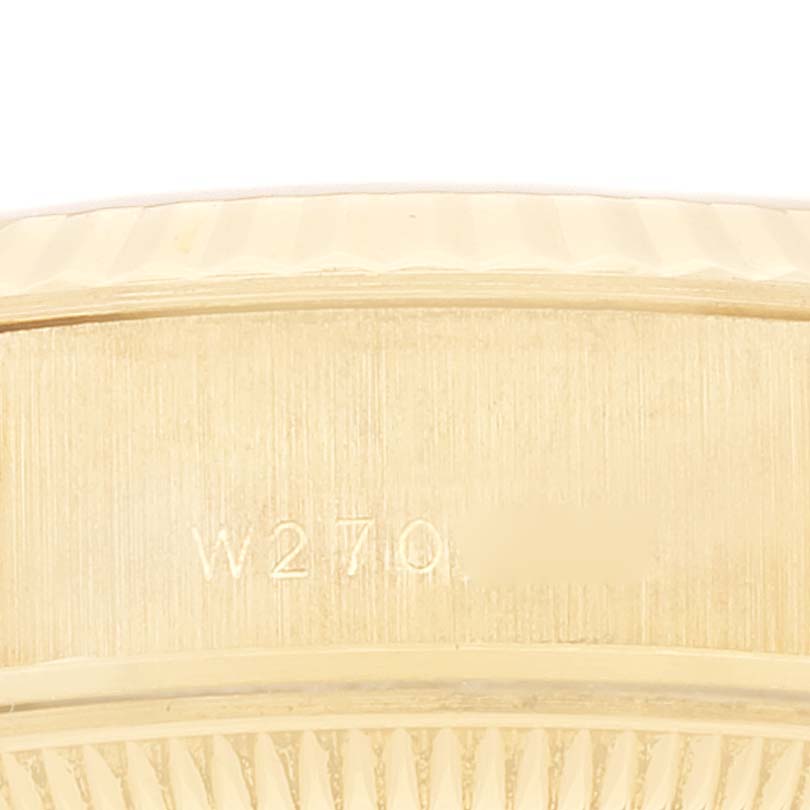 This close-up image shows the side of the Rolex President 69178 Women's Yellow Gold Grey Dial 69178 Women's Yellow Gold Grey Dial watch case with engraved markings.