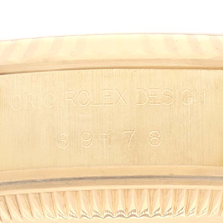 This image shows a close-up of the engraved side of a Rolex President 69178 Women's Yellow Gold Grey Dial 69178 Women's Yellow Gold Grey Dial model watch.