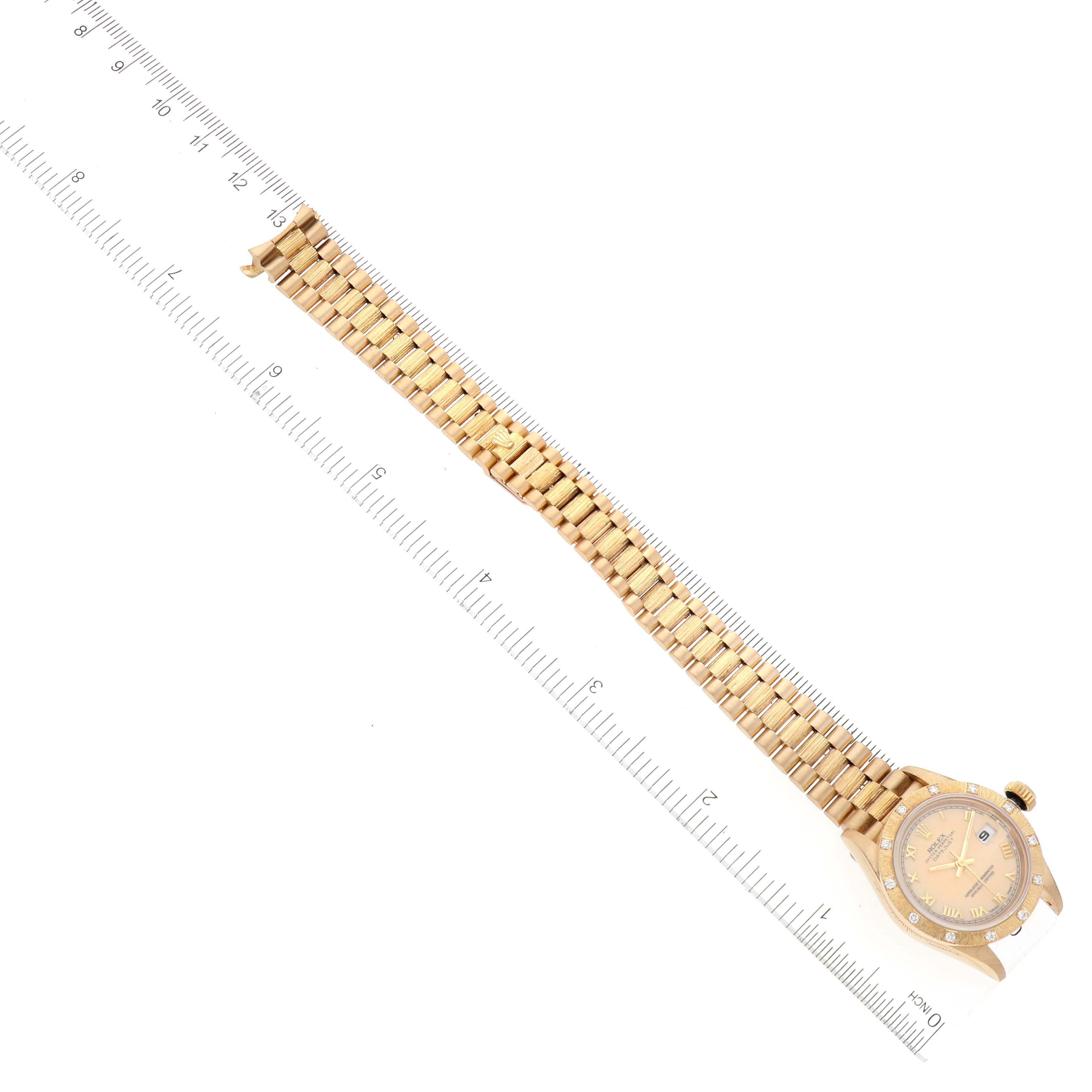 The image shows a Rolex President 69288 Women's Yellow Gold Beige Dial 69288 Women's Yellow Gold Beige Dial model watch laid flat, with its gold bracelet and case visible, next to a ruler for scale.