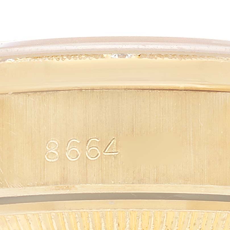 The image shows a close-up of the side profile of a Rolex President 69288 Women's Yellow Gold Beige Dial 69288 Women's Yellow Gold Beige Dial model, focusing on the engraved part of its case or bezel.