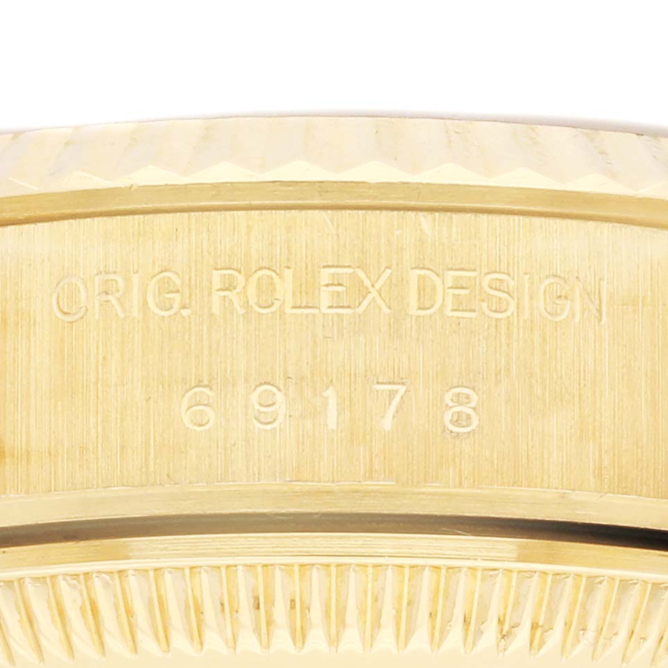 The image shows a close-up of the case edge engraving on a Rolex President 69178 Women's Yellow Gold Champagne Dial 69178 Women's Yellow Gold Champagne Dial model, displaying design details and model number.