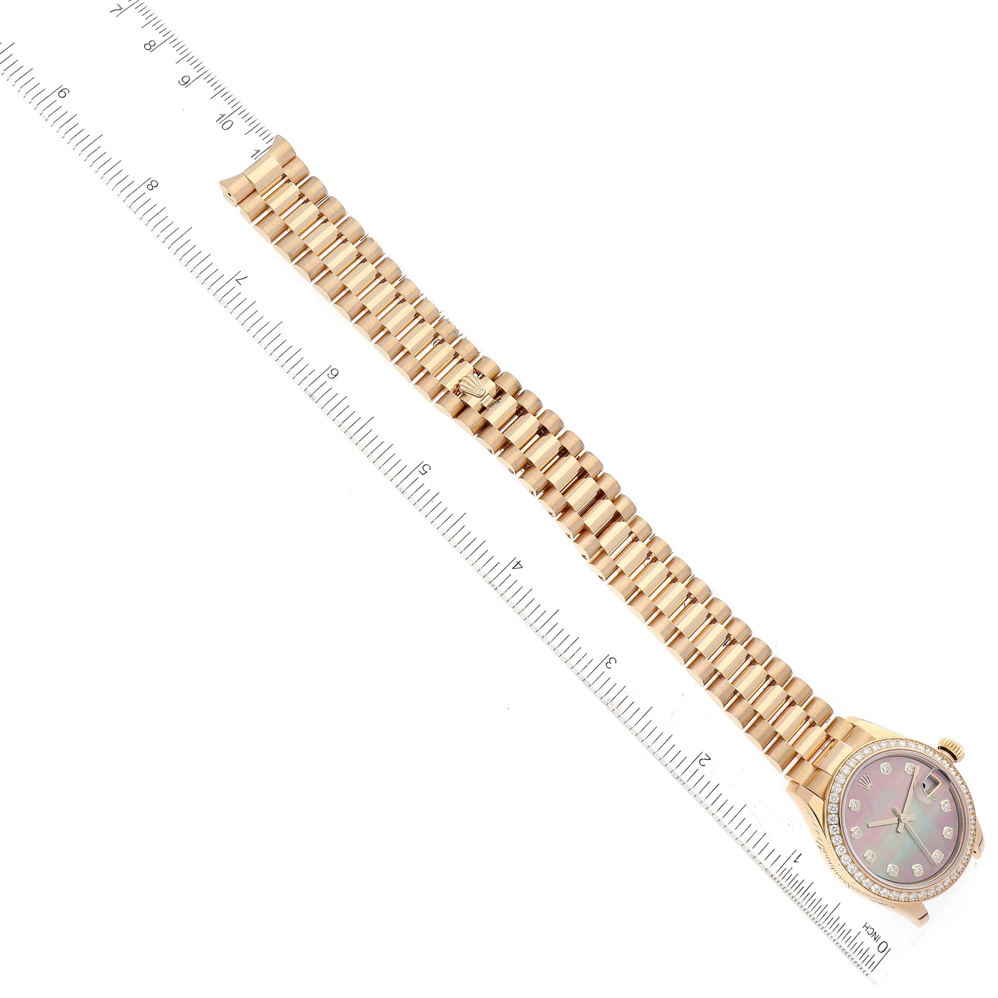 The image shows a top-down view of a Rolex President 278288 Women's Yellow Gold Mother of Pearl Dial 278288 Women's Yellow Gold Mother of Pearl Dial watch, highlighting its face and gold bracelet next to a ruler for scale.