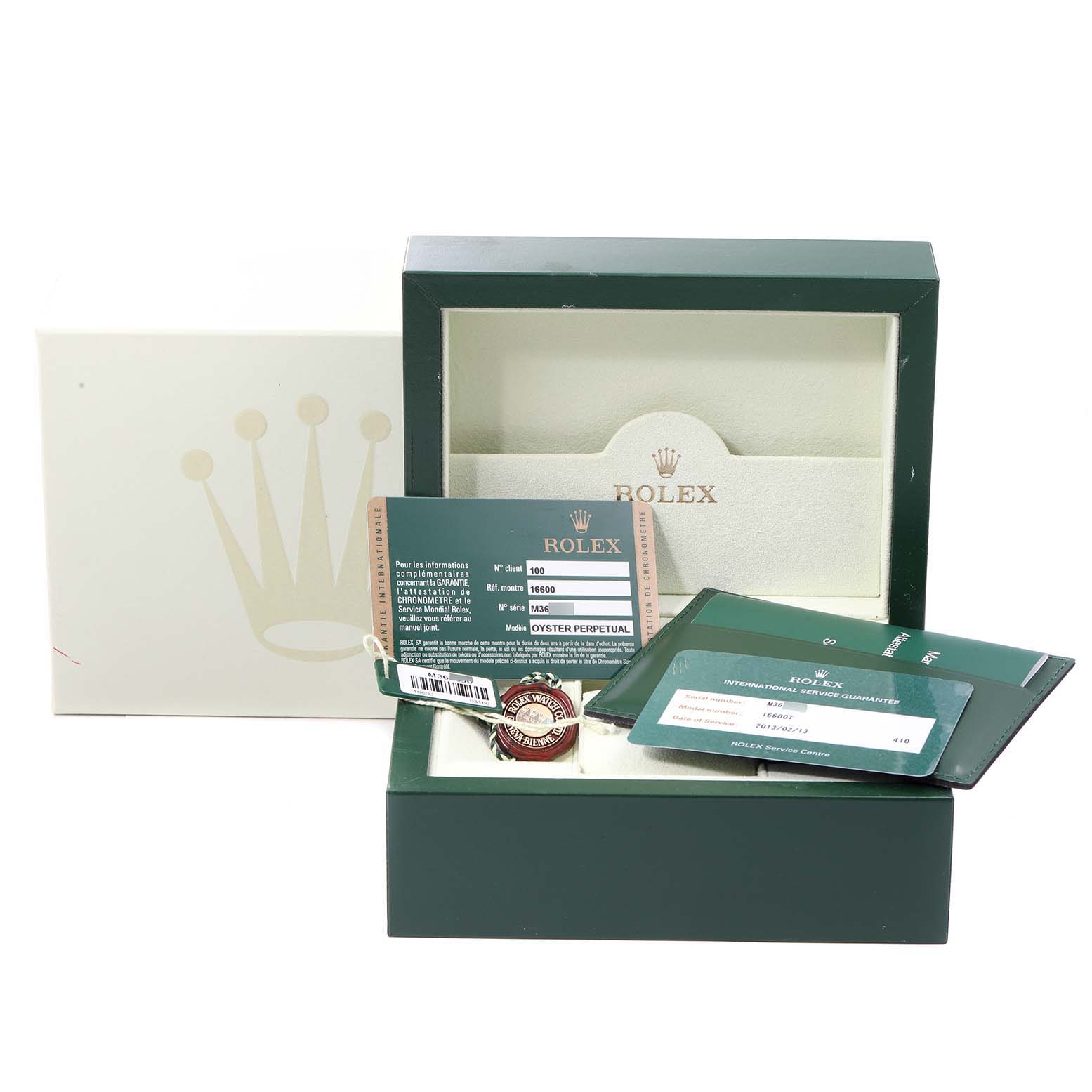 The image shows a Rolex Sea-Dweller 16600 Men
s Stainless Steel Black Dial 16600 Men
s Stainless Steel Black Dial watch box, guarantee card, and accessories, viewed from the front.