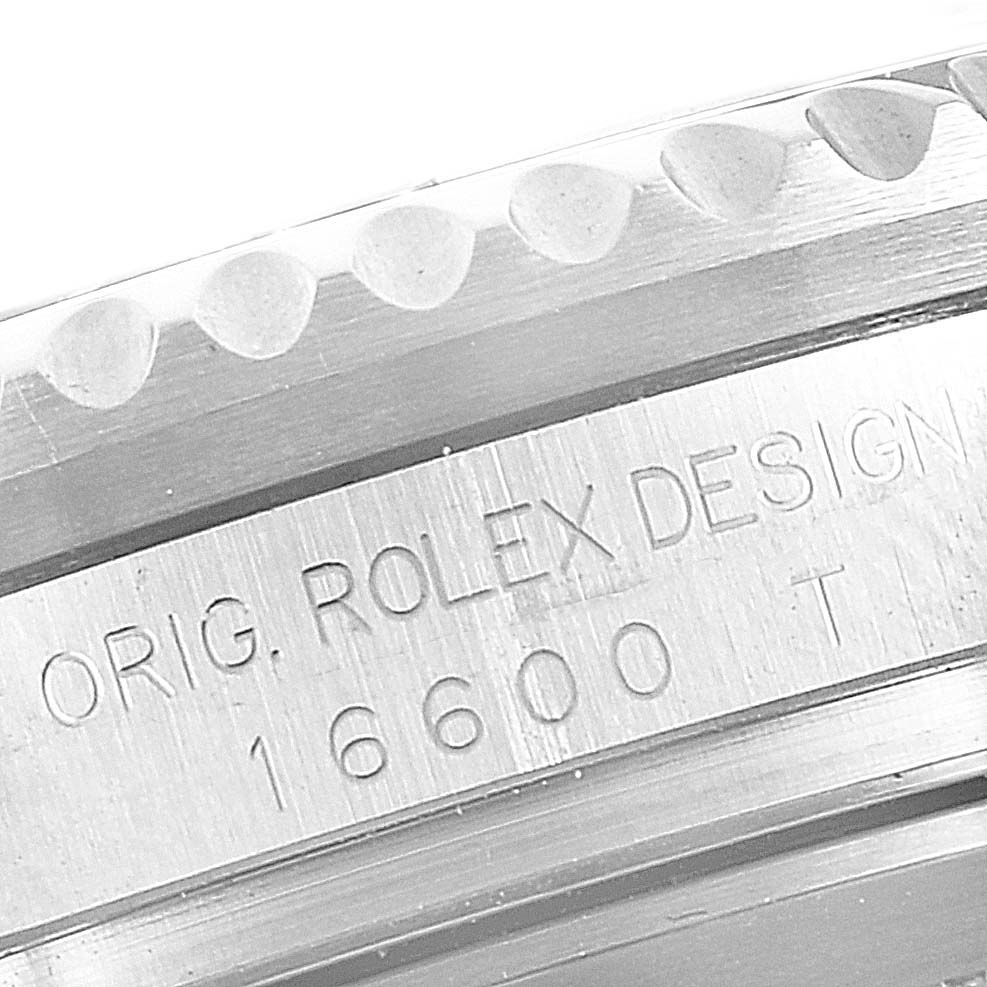 A close-up view shows the case side and engraved reference number "16600" of the Rolex Sea-Dweller 16600 Men
s Stainless Steel Black Dial 16600 Men
s Stainless Steel Black Dial model.