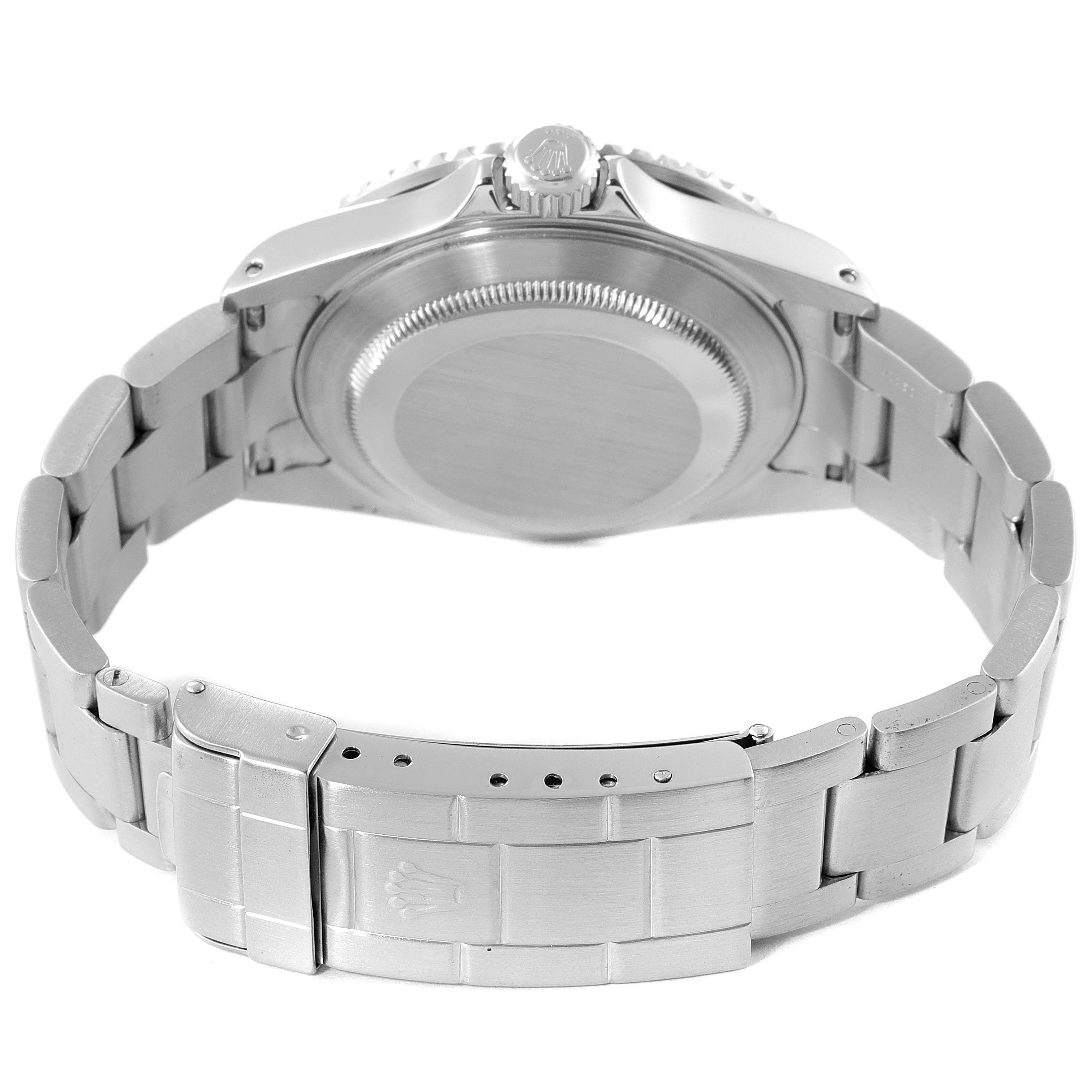 The image shows a Rolex Submariner 16610 Men
s Stainless Steel Black Dial 16610 Men
s Stainless Steel Black Dial from the backside, displaying the case back, bracelet, and clasp.