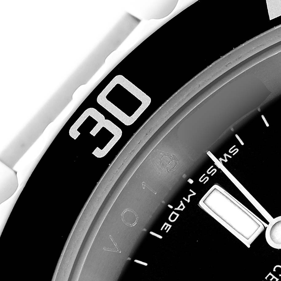 The image shows a close-up of the Rolex Submariner 16610 Men's Stainless Steel Black Dial 16610 Men's Stainless Steel Black Dial's bezel and part of the dial, specifically the "30" minute marker and hour hand.