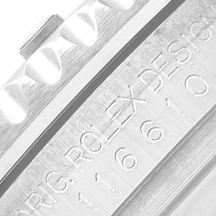 The image shows a close-up of the Rolex Submariner 116610LV Men's Stainless Steel Green Dial 116610LV Men's Stainless Steel Green Dial's bezel edge and engraved markings on the case side.