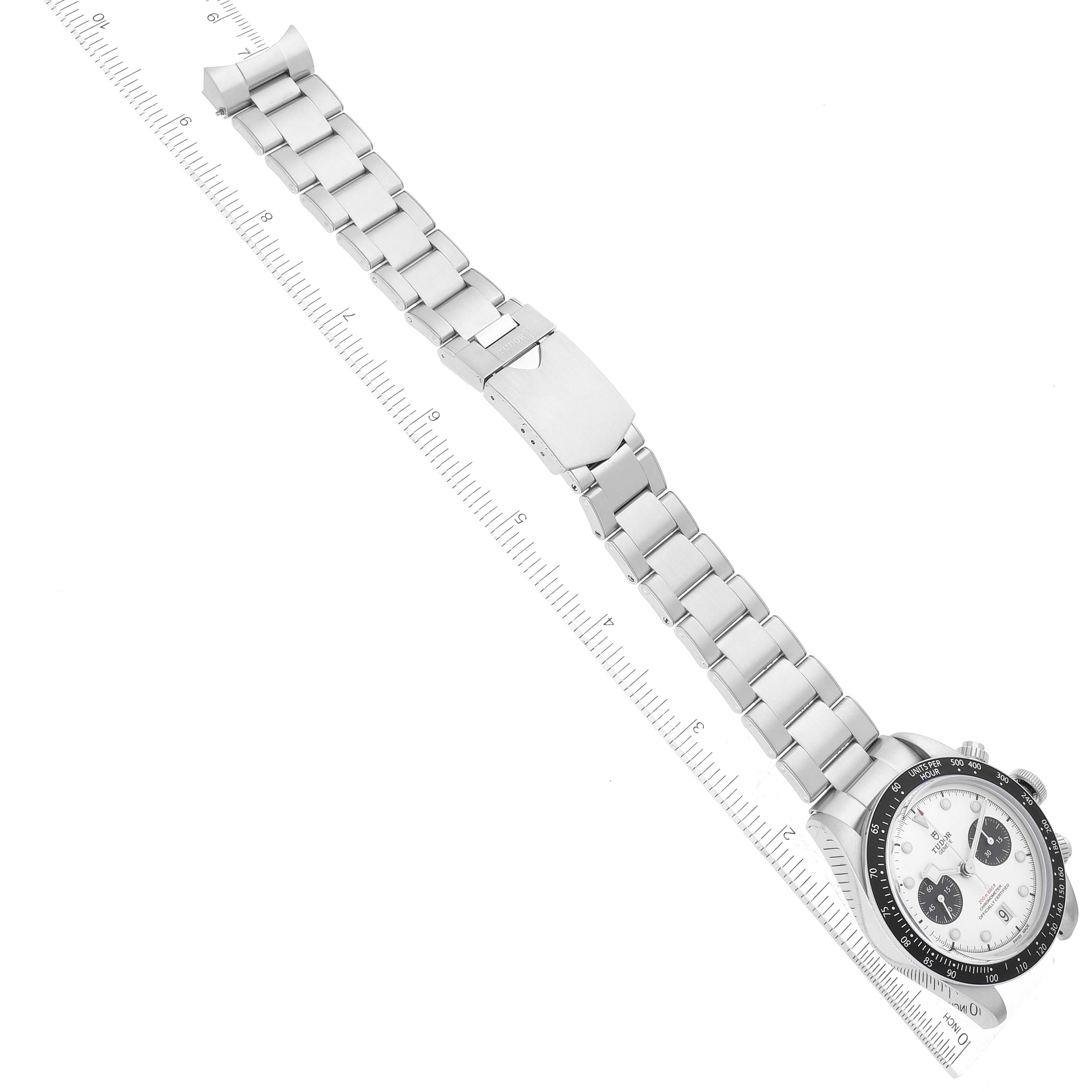 The image shows the Tudor Heritage Black Bay M79360N-0002 Men's Stainless Steel Silver Dial M79360N-0002 Men's Stainless Steel Silver Dial watch placed diagonally with a ruler for scale, highlighting the dial and metal bracelet.