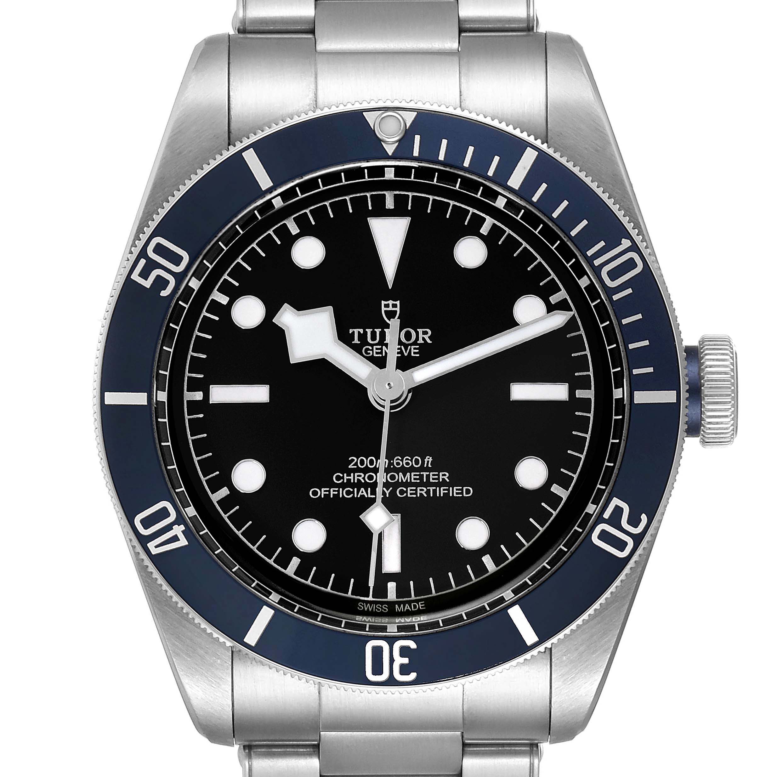 The Tudor Heritage Black Bay 79230B Men
s Stainless Steel Black Dial 79230B Men
s Stainless Steel Black Dial watch is shown from a front angle, displaying its dial, bezel, and part of the bracelet.