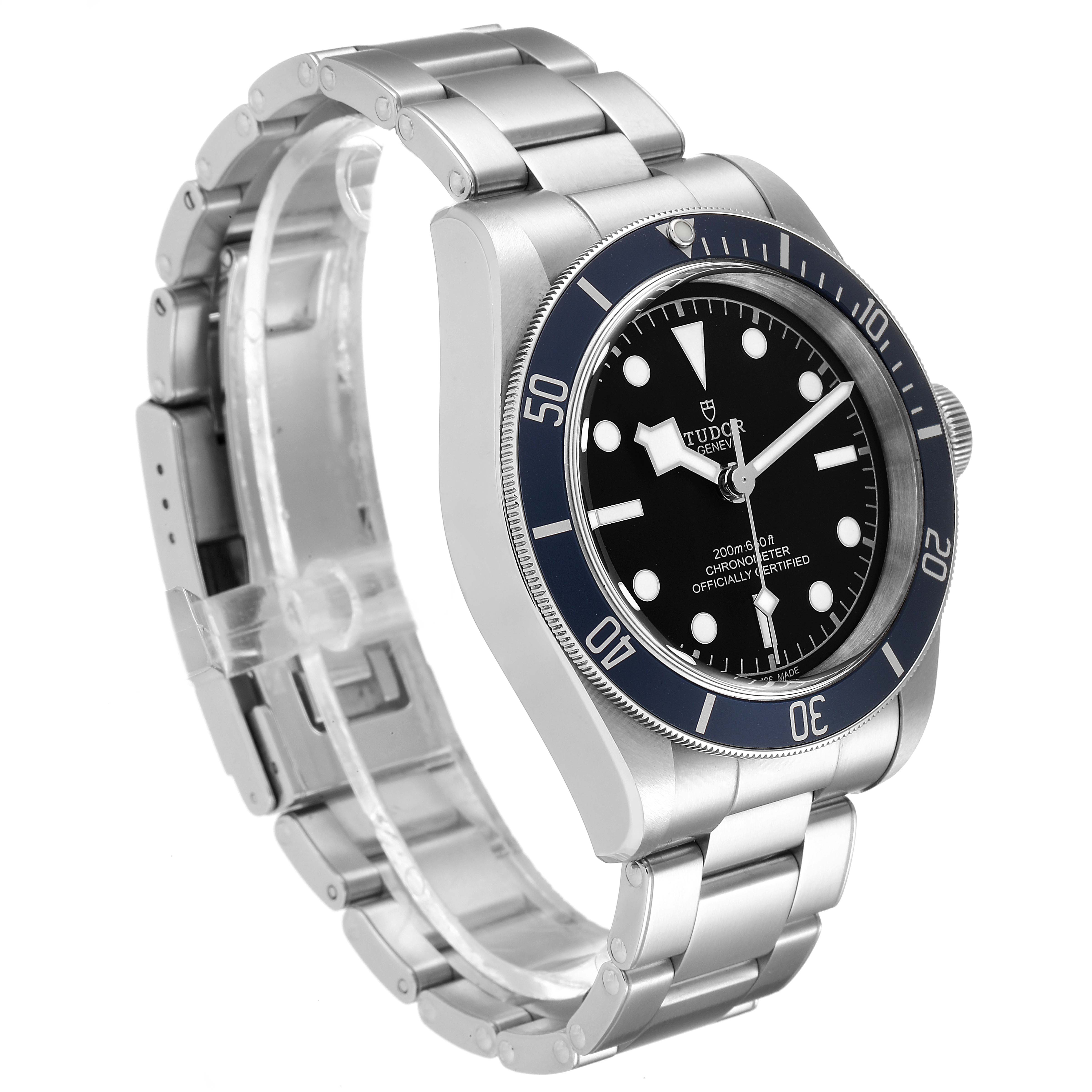 The Tudor Heritage Black Bay 79230B Men
s Stainless Steel Black Dial 79230B Men
s Stainless Steel Black Dial watch is shown from an angled side view, displaying the bezel, dial, crown, and metal bracelet.