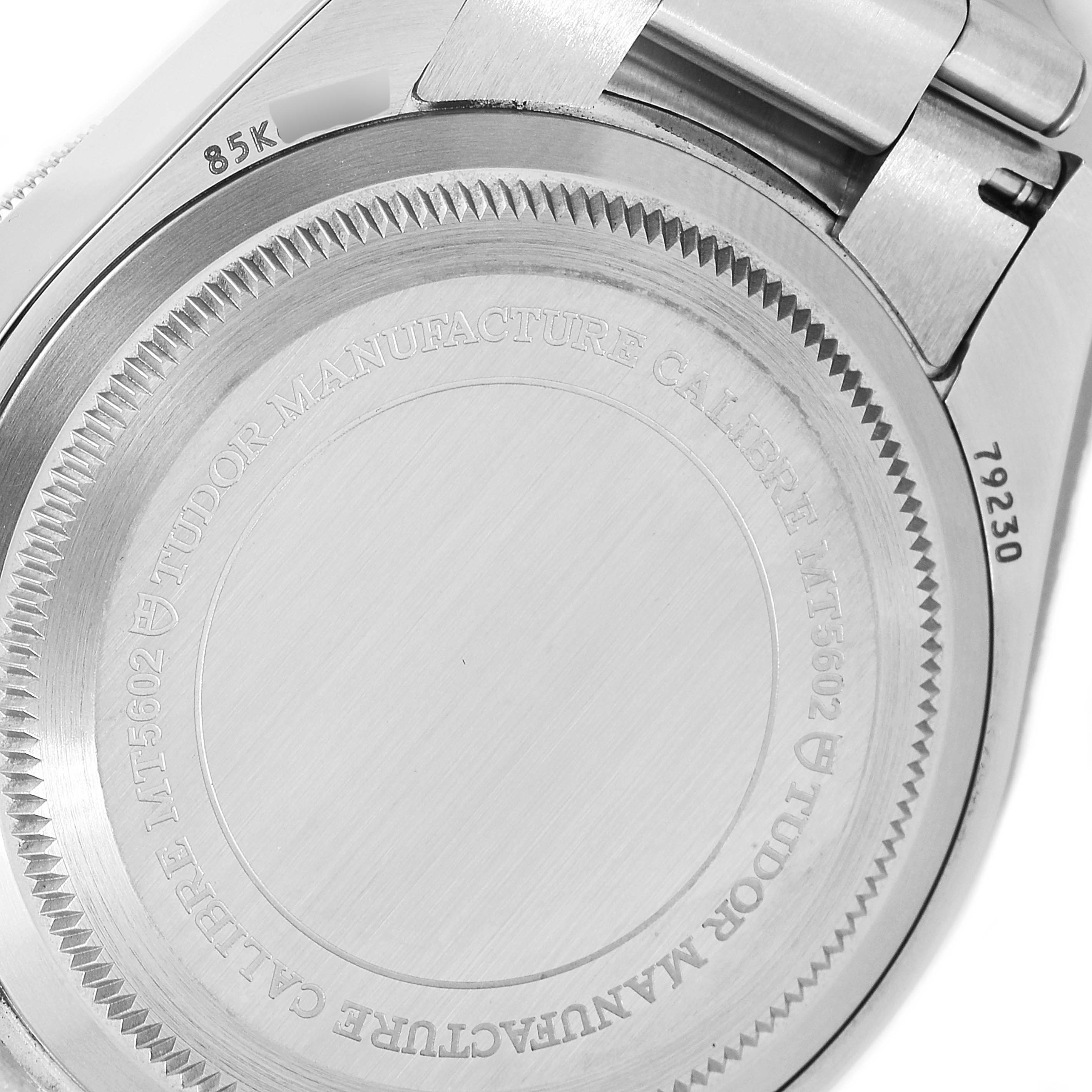 The image shows the back case and part of the bracelet clasp of a Tudor Heritage Black Bay 79230B Men
s Stainless Steel Black Dial 79230B Men
s Stainless Steel Black Dial watch.