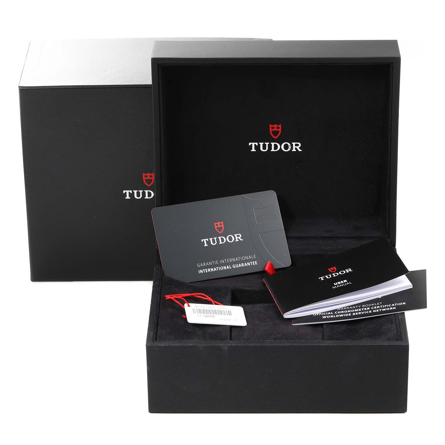 This image shows the packaging, warranty card, tags, and user manual for the Tudor Heritage Black Bay 79830RB Men
s Stainless Steel Black Dial 79830RB Men
s Stainless Steel Black Dial watch.