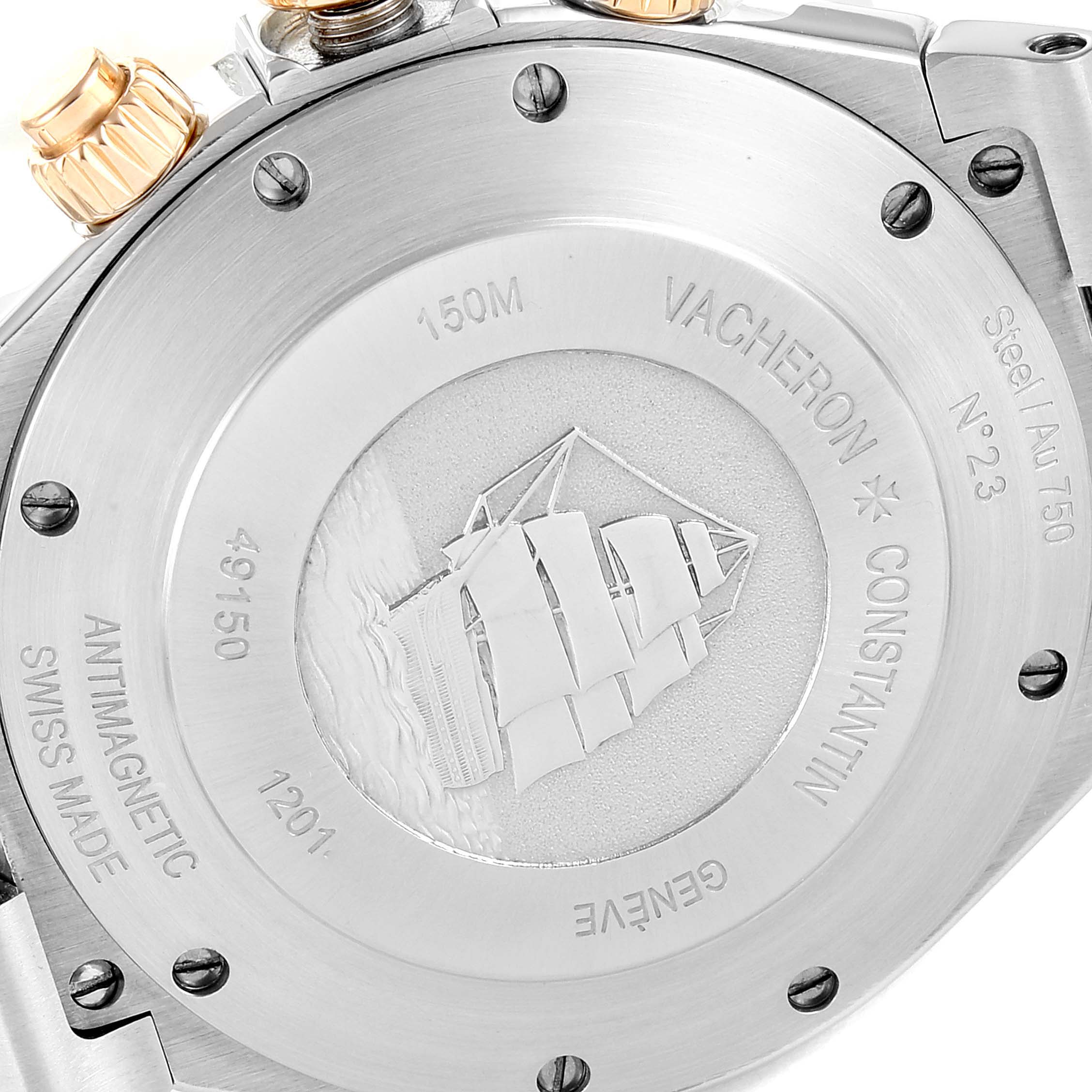 The image shows the back case of a Vacheron Constantin Overseas 49150/000M-9338 Men's Steel and Gold (two tone) Grey Dial 49150/000M-9338 Men's Steel and Gold (two tone) Grey Dial model watch, highlighting its engravings and screws.