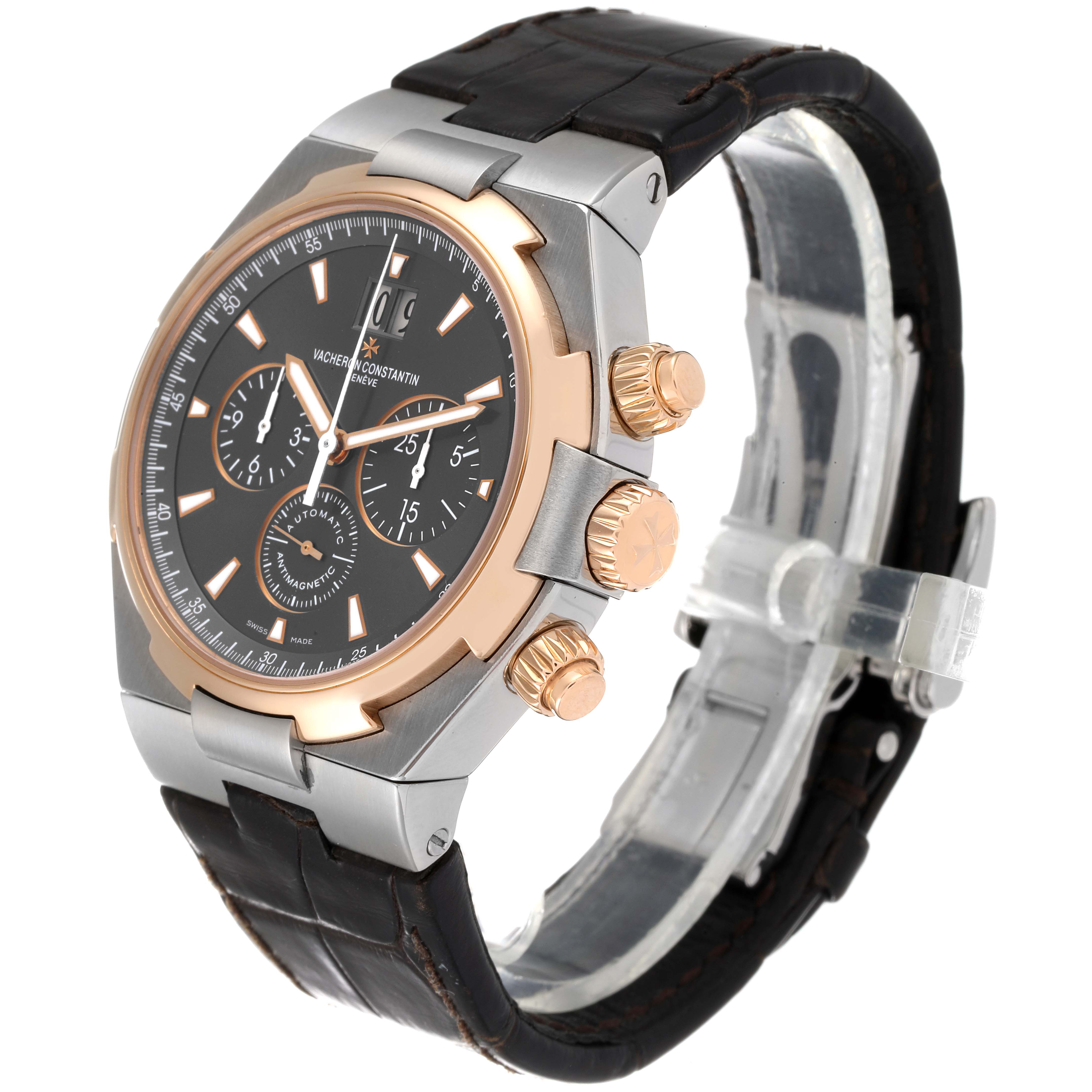 The image shows a side angle of a Vacheron Constantin Overseas 49150/000M-9338 Men's Steel and Gold (two tone) Grey Dial 49150/000M-9338 Men's Steel and Gold (two tone) Grey Dial watch featuring its face, bezel, crown, and strap.