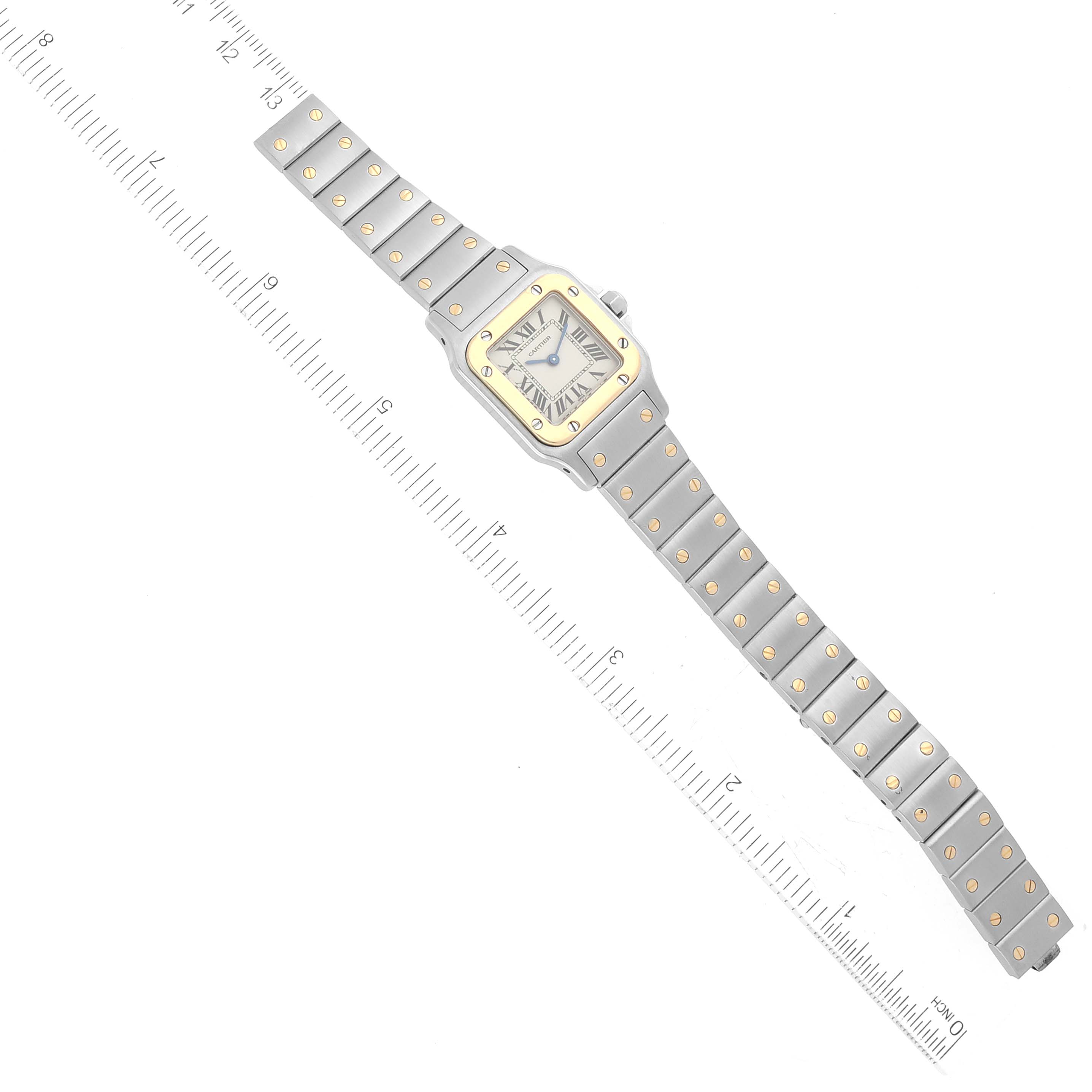 The Cartier Santos W20012C4 Women's Stainless Steel Silver Dial W20012C4 Women's Stainless Steel Silver Dial watch is displayed flat with a ruler for scale, showing the entire bracelet and face.