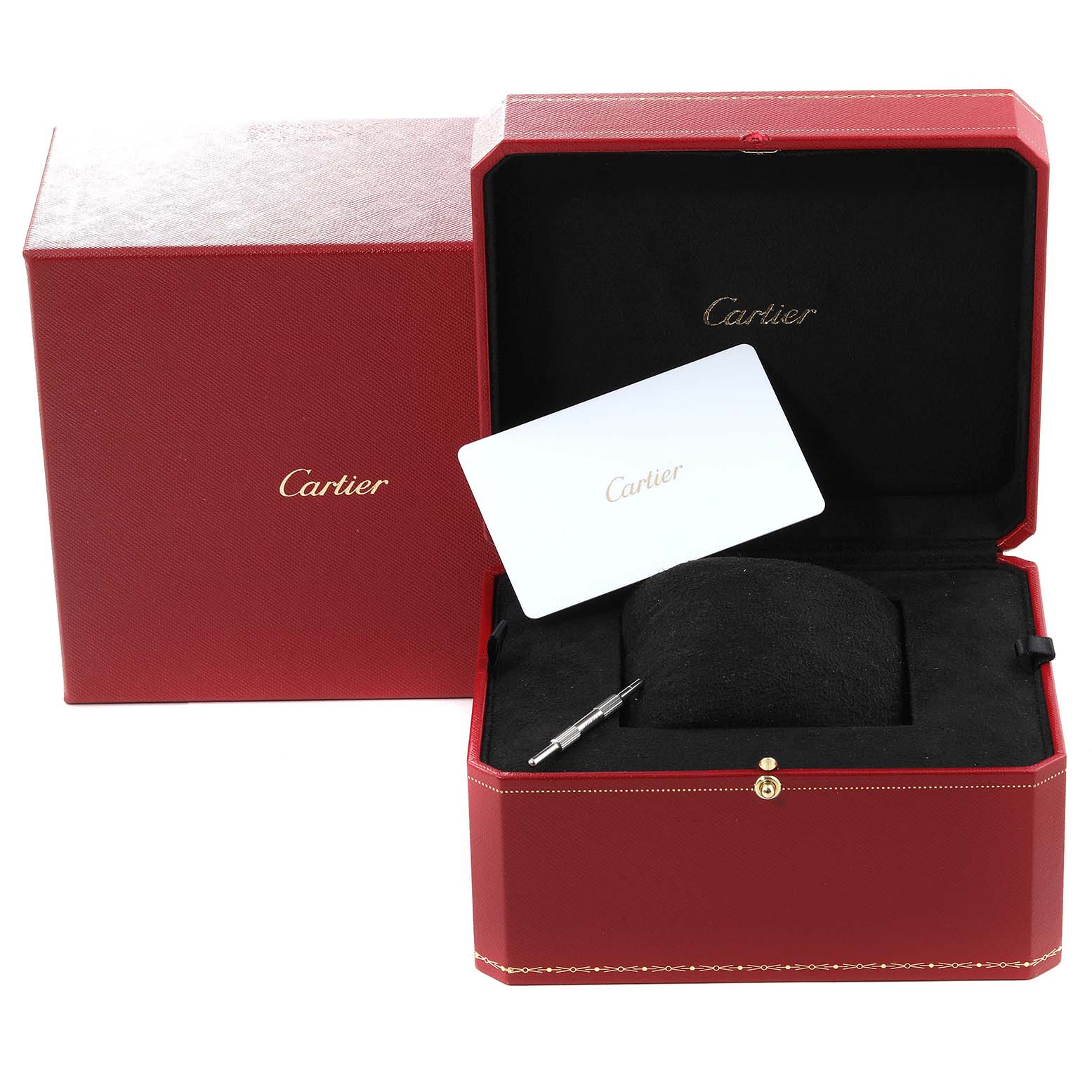 This image shows the red Cartier Santos WSSA0029 Men
s Stainless Steel Silver Dial WSSA0029 Men
s Stainless Steel Silver Dial watch box, with a cushion, a metal tool, and a white Cartier card inside.