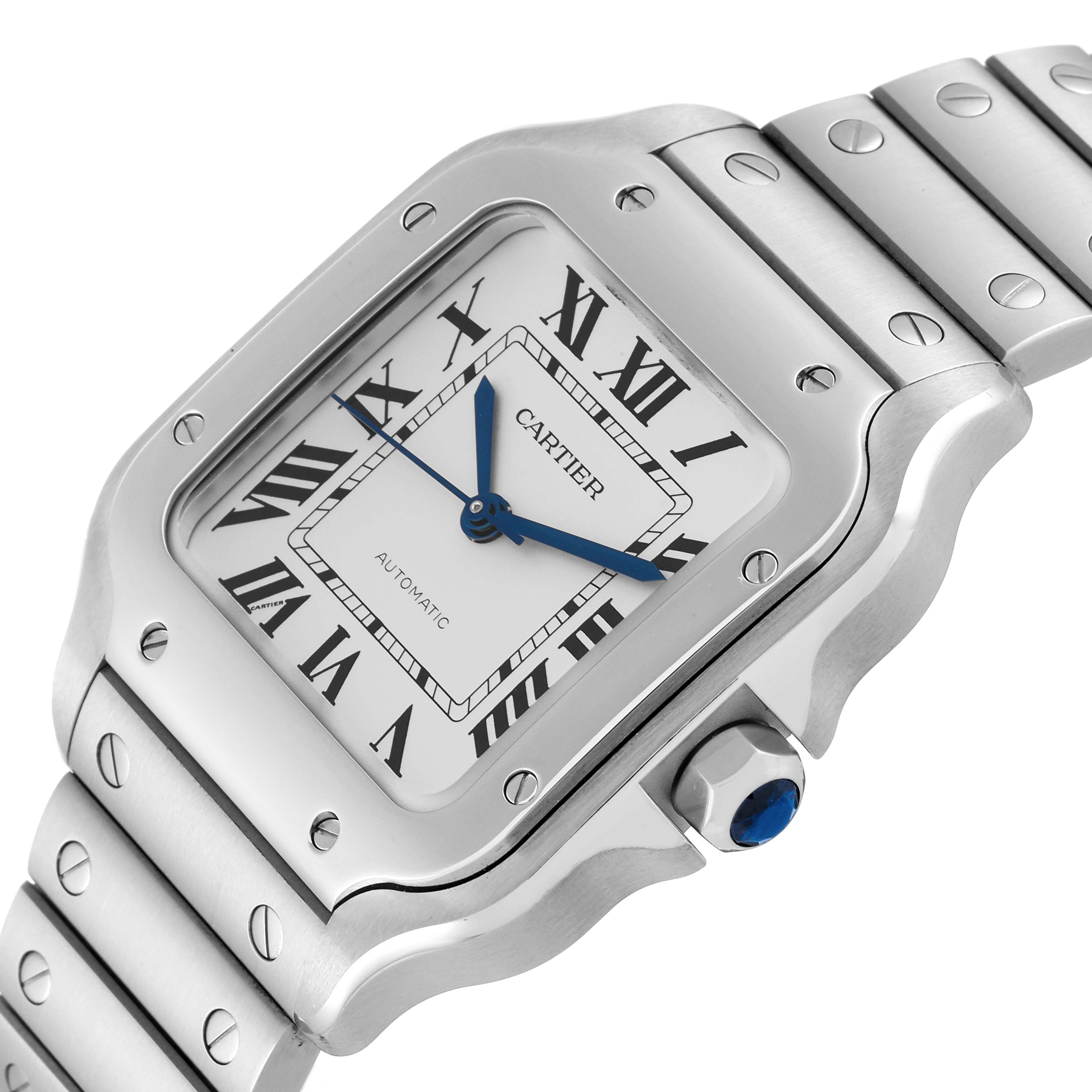 The image shows a close-up angle of the Cartier Santos WSSA0029 Men
s Stainless Steel Silver Dial WSSA0029 Men
s Stainless Steel Silver Dial watch, highlighting the face, bezel, and part of the metal bracelet.