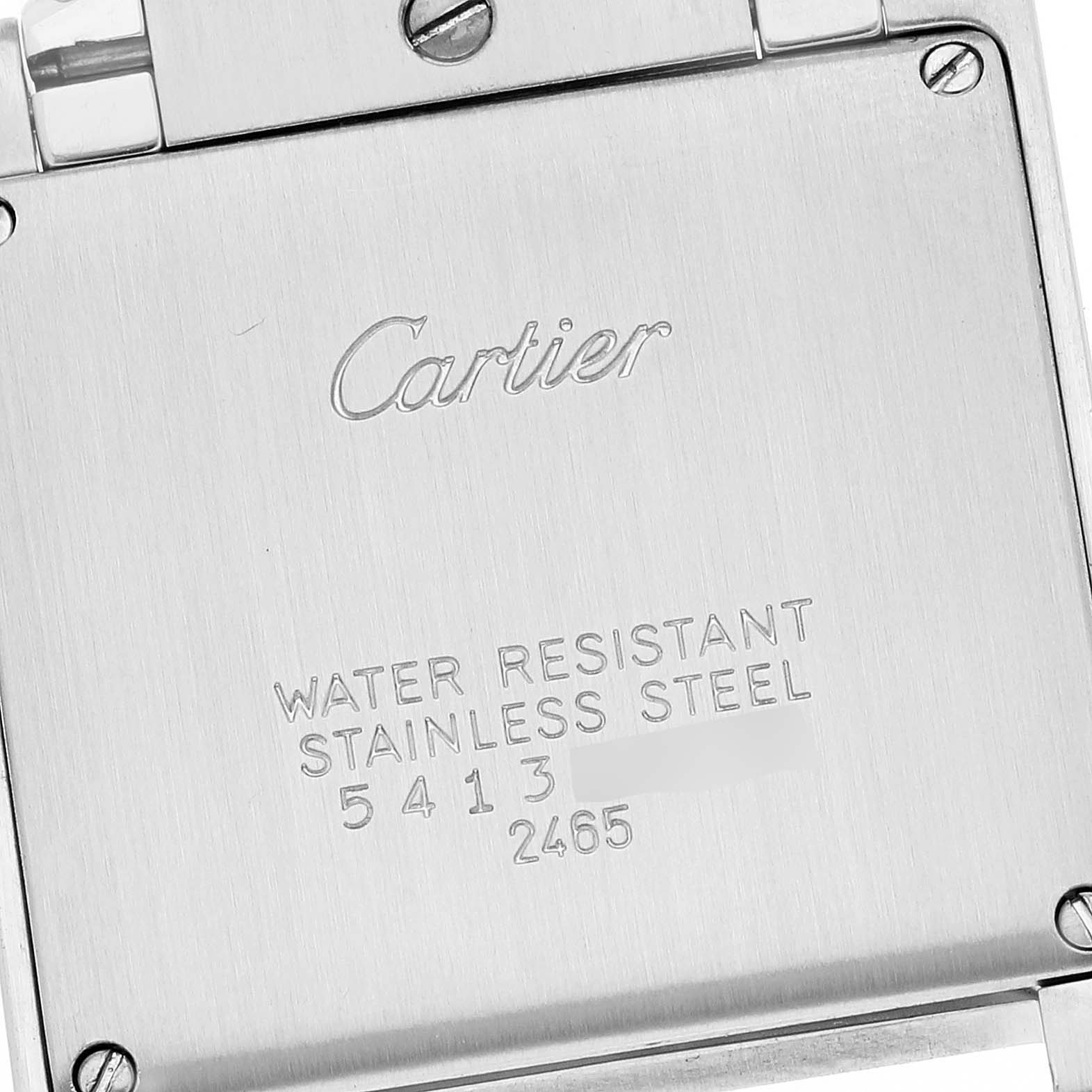 This image shows the back case of a Tank Française model by Cartier, engraved with the brand name and specifications.
