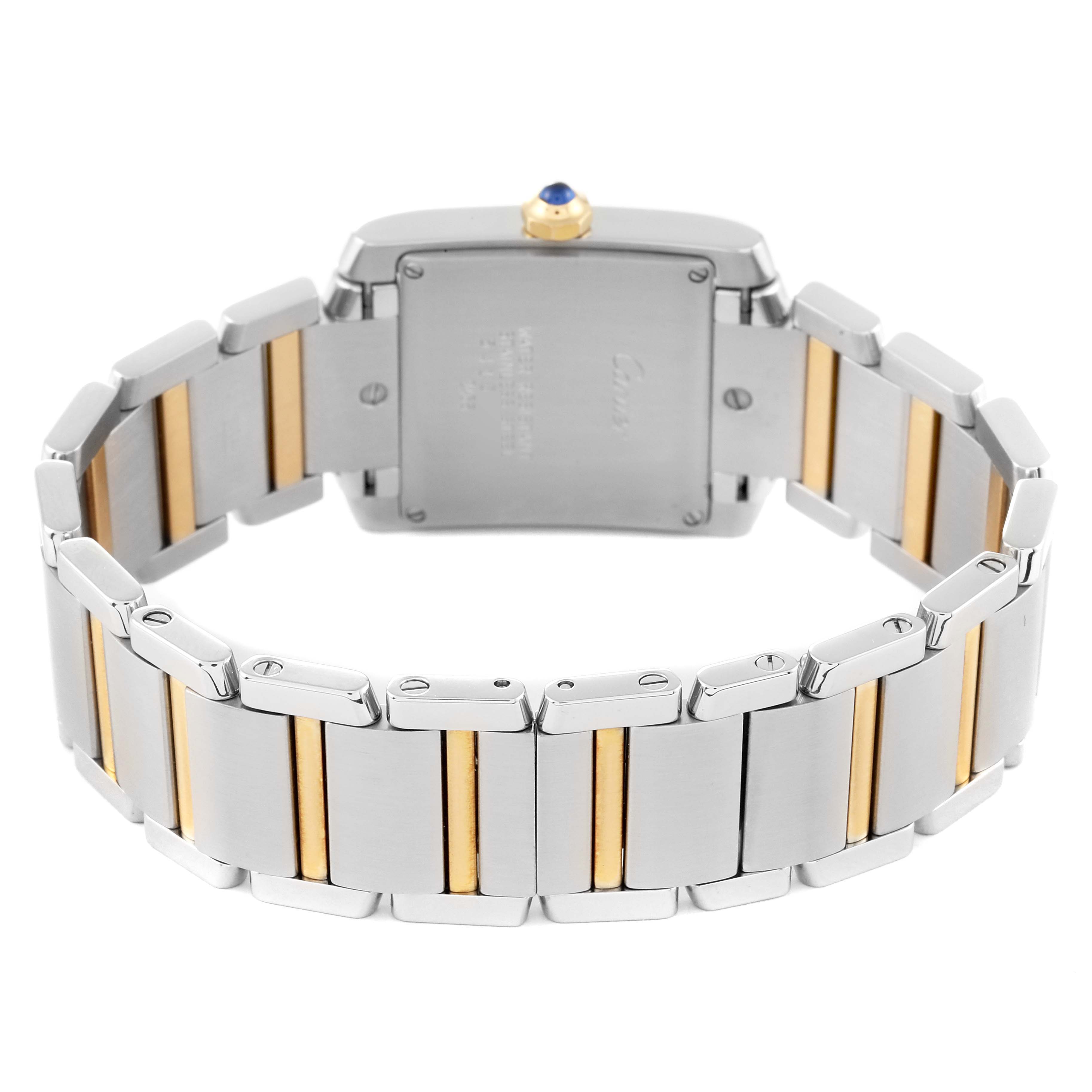 The image shows the back view of a Cartier Tank Française watch, highlighting the metal bracelet with gold accents and the case back.