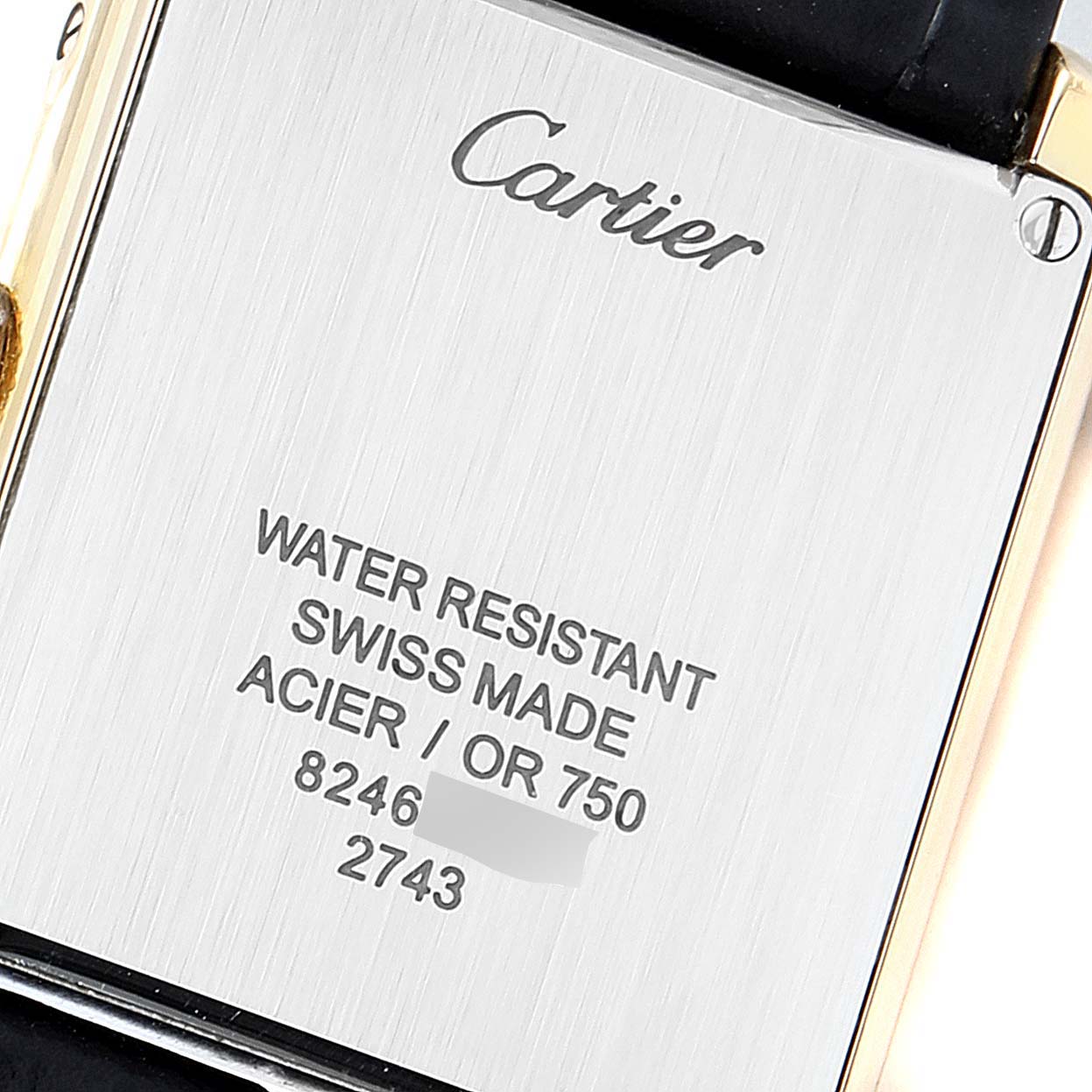 The image shows the back case of a Cartier Tank Solo 290730PL Women
s Yellow Gold Silver Dial 290730PL Women
s Yellow Gold Silver Dial watch, displaying inscriptions of water resistance, materials, and serial numbers.