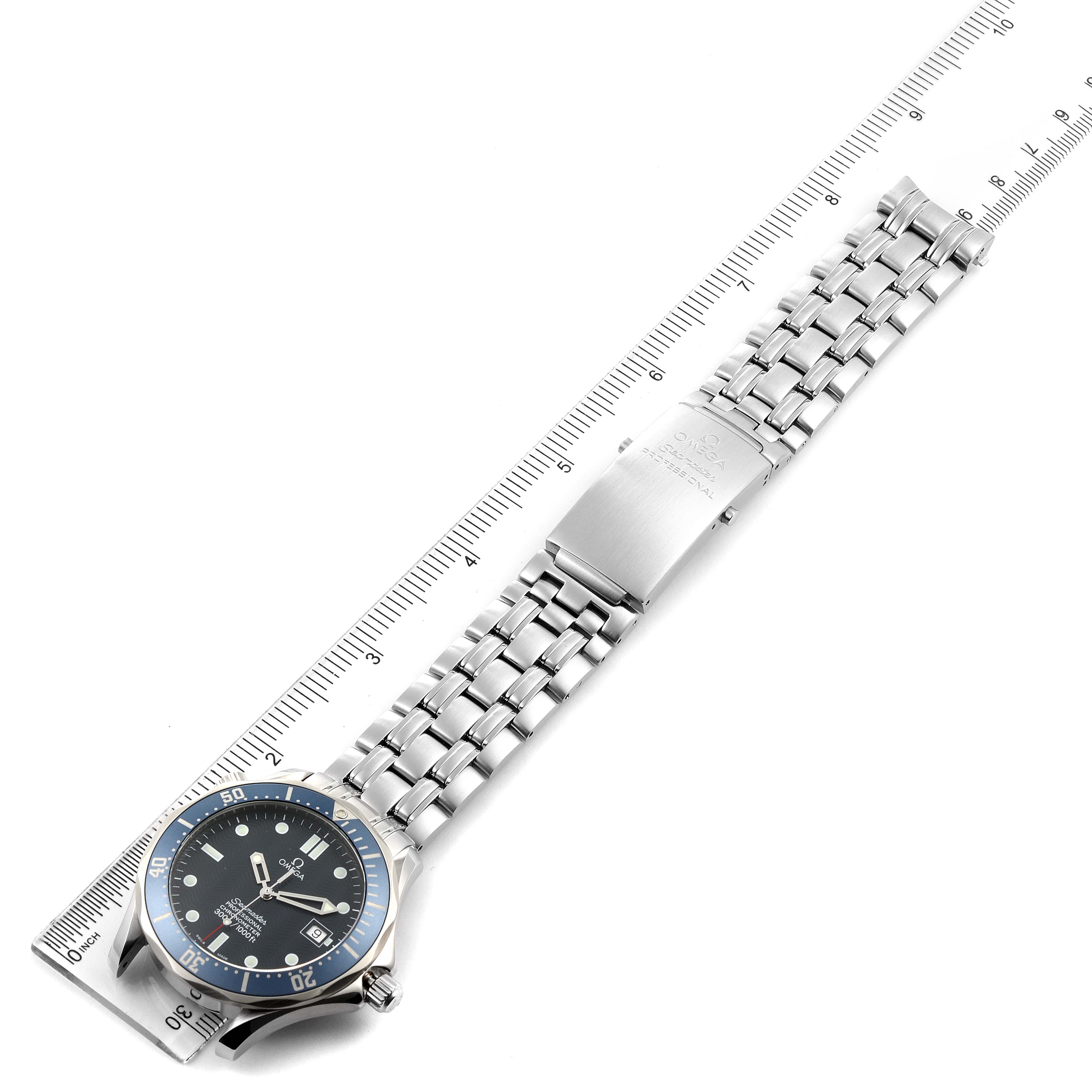The image shows an Omega Seamaster 2531.80.00 Men
s Stainless Steel Blue Dial 2531.80.00 Men
s Stainless Steel Blue Dial watch laid flat, displaying the face, metal bracelet, and clasp, alongside a ruler for scale.